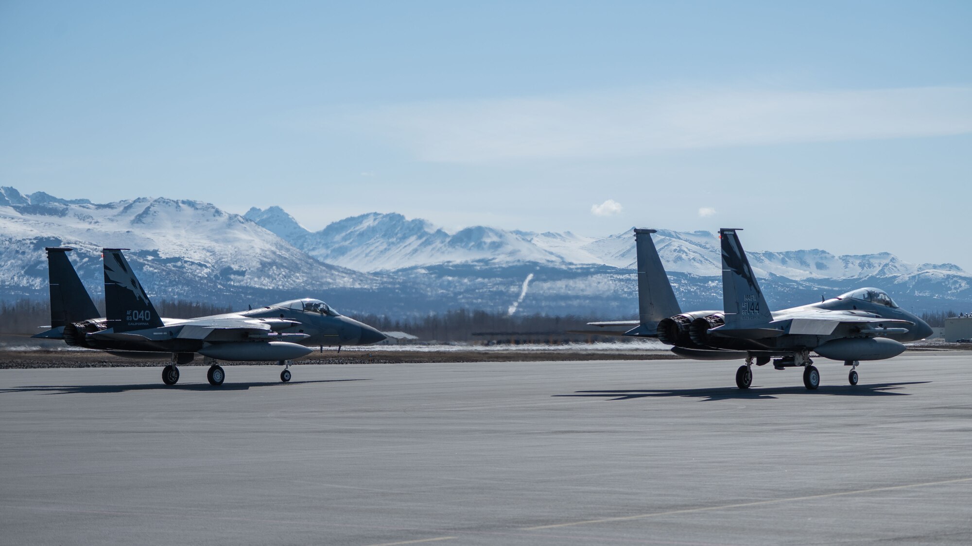 A photo of 2 F-15 Eagles sitting on the flight line.