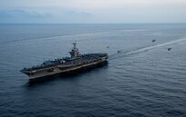 An MH-60S Sea Hawk helicopter, attached to the "Dragonslayers" of Helicopter Sea Combat Squadron (HSC) 11, a Eurocopter AS365 Dauphin helicopter, attached to the French aircraft carrier Charles de Gaulle (R 91) and two NHIndustries NH90 helicopters, attached to the Italian aircraft carrier ITS Cavour (C 550), fly in formation alongside the Nimitz-class aircraft carrier USS Harry S. Truman (CVN 75), Mar. 17, 2022.