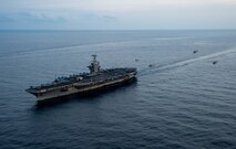 An MH-60S Sea Hawk helicopter, attached to the "Dragonslayers" of Helicopter Sea Combat Squadron (HSC) 11, a Eurocopter AS365 Dauphin helicopter, attached to the French aircraft carrier Charles de Gaulle (R 91) and two NHIndustries NH90 helicopters, attached to the Italian aircraft carrier ITS Cavour (C 550), fly in formation alongside the Nimitz-class aircraft carrier USS Harry S. Truman (CVN 75), Mar. 17, 2022.