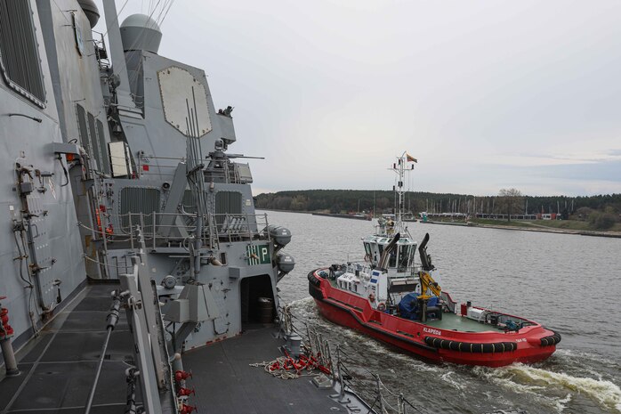Lithuanian tugboat TAK-10, right, sails beside Arleigh Burke-class guided-missile destroyer USS Gravely (DDG 107), left, while Gravely arrives at the Klaipeda, Lithuania, for a scheduled port visit, April 24, 2022.