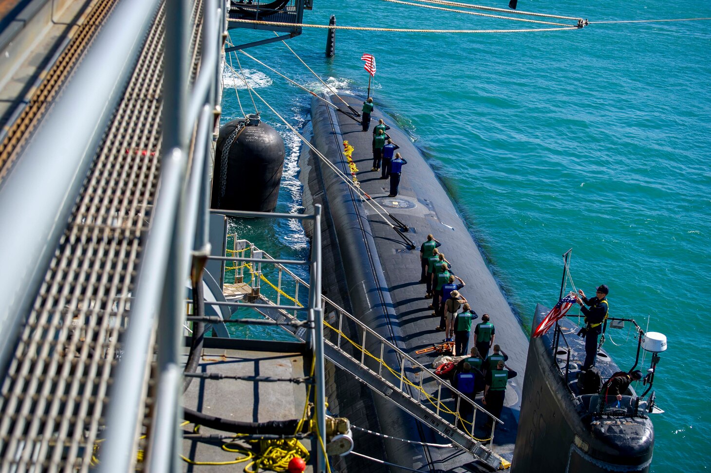PERTH, Australia (April 23, 2022) Sailors assigned to the Los Angeles-class fast-attack submarine USS Springfield (SSN 761) observe the raising of the national ensign, April 23, 2022. Springfield is moored alongside the Emory S. Land-class submarine tender USS Frank Cable (AS 40) at HMAS Stirling Navy Base. Frank Cable is currently on patrol conducting expeditionary maintenance and logistics in support of national security in the U.S. 7th Fleet area of operations. (U.S. Navy photo by Mass Communication Specialist Seaman Wendy Arauz/Released)