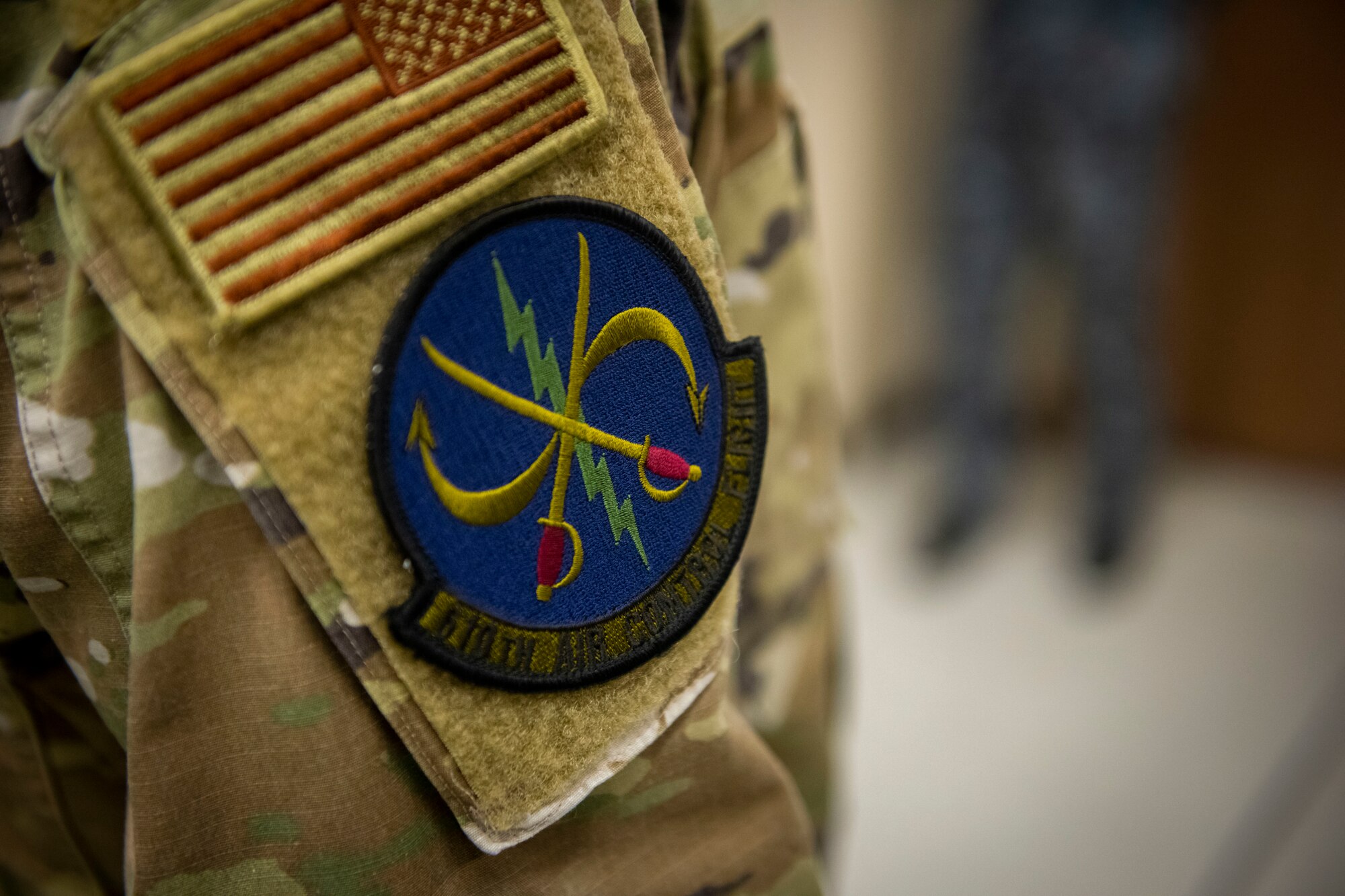 Military member in uniform displays a patch on his shoulder, that reads "Camel".
