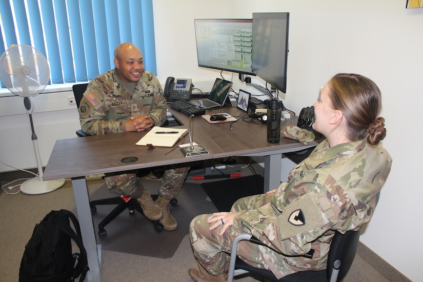 Army Maj. Darryl Bailey, the support operations officer for Army Field Support Battalion-Germany, 405th Army Field Support Brigade, discusses future operations with a fellow AFSBn-Germany staff officer at the battalion headquarters in Vilseck, Germany, April 22. Bailey said AFSBn-Germany is the first battalion in the 405th AFSB to become a multifunctional and regionally aligned AFSBn. The battalion’s multifunctional capabilities include its Logistics Civil Augmentation Program, Logistics Assistance Program and Army Prepositioned Stocks-2 missions. (Photo by Steven Briscoe)