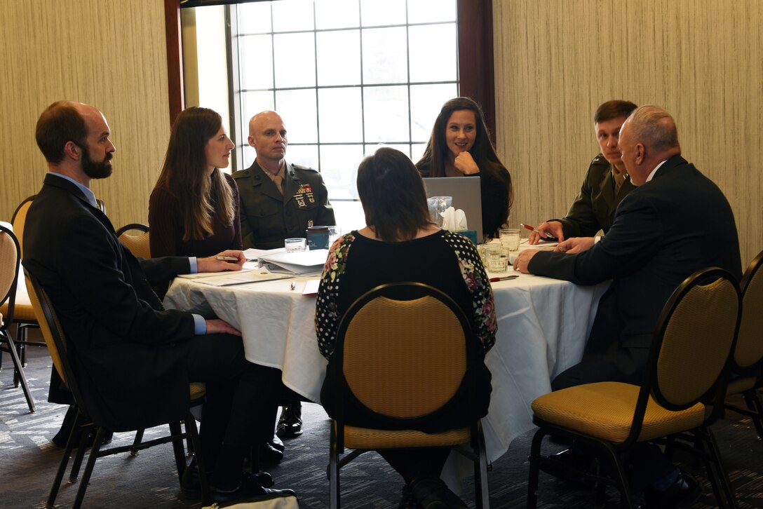 Members of the Defense POW/MIA Accounting Agency speak to a family attending the family member update in Minneapolis, April 23, 2022. DPAA provides periodic updates and hosts annual government briefings for families of Americans who are missing from past conflicts. (U.S. Army photo by Sgt. 1st Class Corey Idleburg)