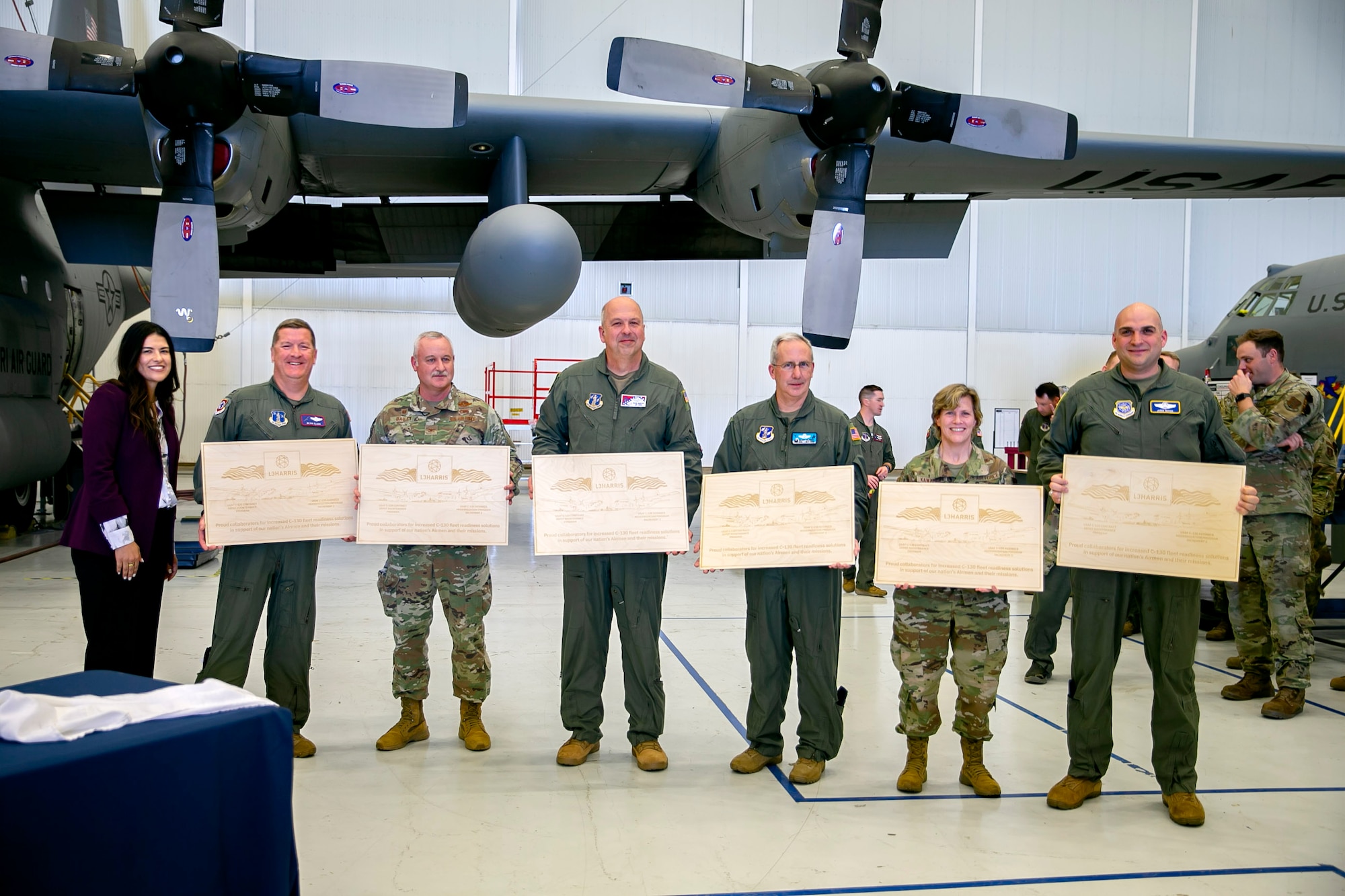 Pictured left to right:  Sara Tatsch (L3H), Col. John Cluck (139th Airlift Wing), Col. Doug Bailey (139th Airlift Wing ), Col. Dean Martin (189th Airlift Wing), Col. Barry Deibert (153rd Airlift Wing), Col. Audrey Kawanishi (ANG Advisor to the Commander), Lt. Col. Tanner (Chief, Airlift Requirements Division, AMC) during a ribbon cutting ceremony earlier this month to mark the completion of the first Trial Kit Installation onto a C-130H from the 139th Airlift Wing. (Courtesy photo)