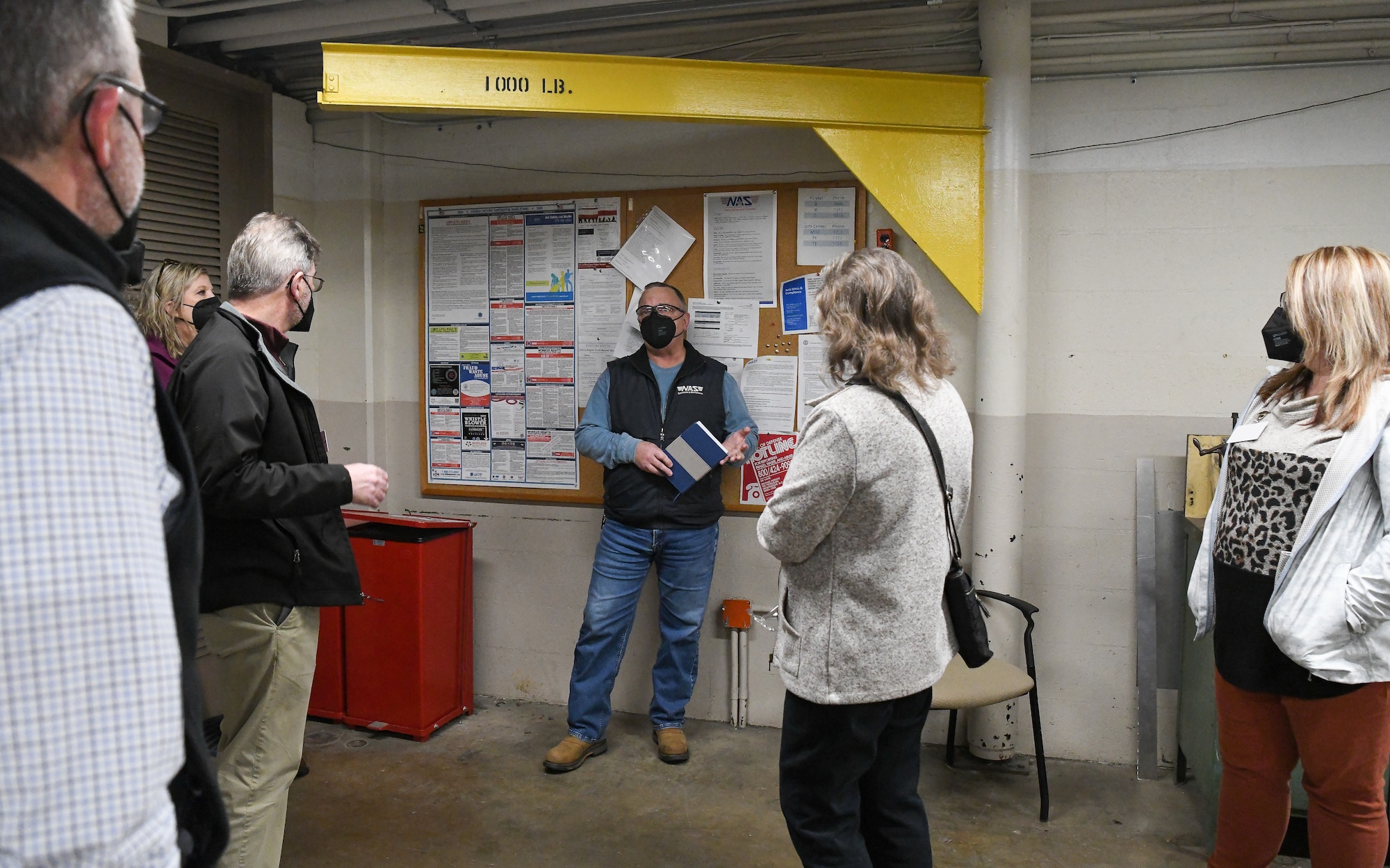 Mike Hollowell, center, Operations and Maintenance functional manager with the Test Operations and Sustainment contractor for Arnold Engineering Development Complex, answers questions from local teachers and school administrators during a tour of facilities at Arnold Air Force Base, Tenn., Feb. 23, 2022. The educators were being shown the trade job opportunities available at the base to be able to share the information with their students. (U.S. Air Force photo by Jill Pickett) (This image has been altered by obscuring a badge for security purposes.)