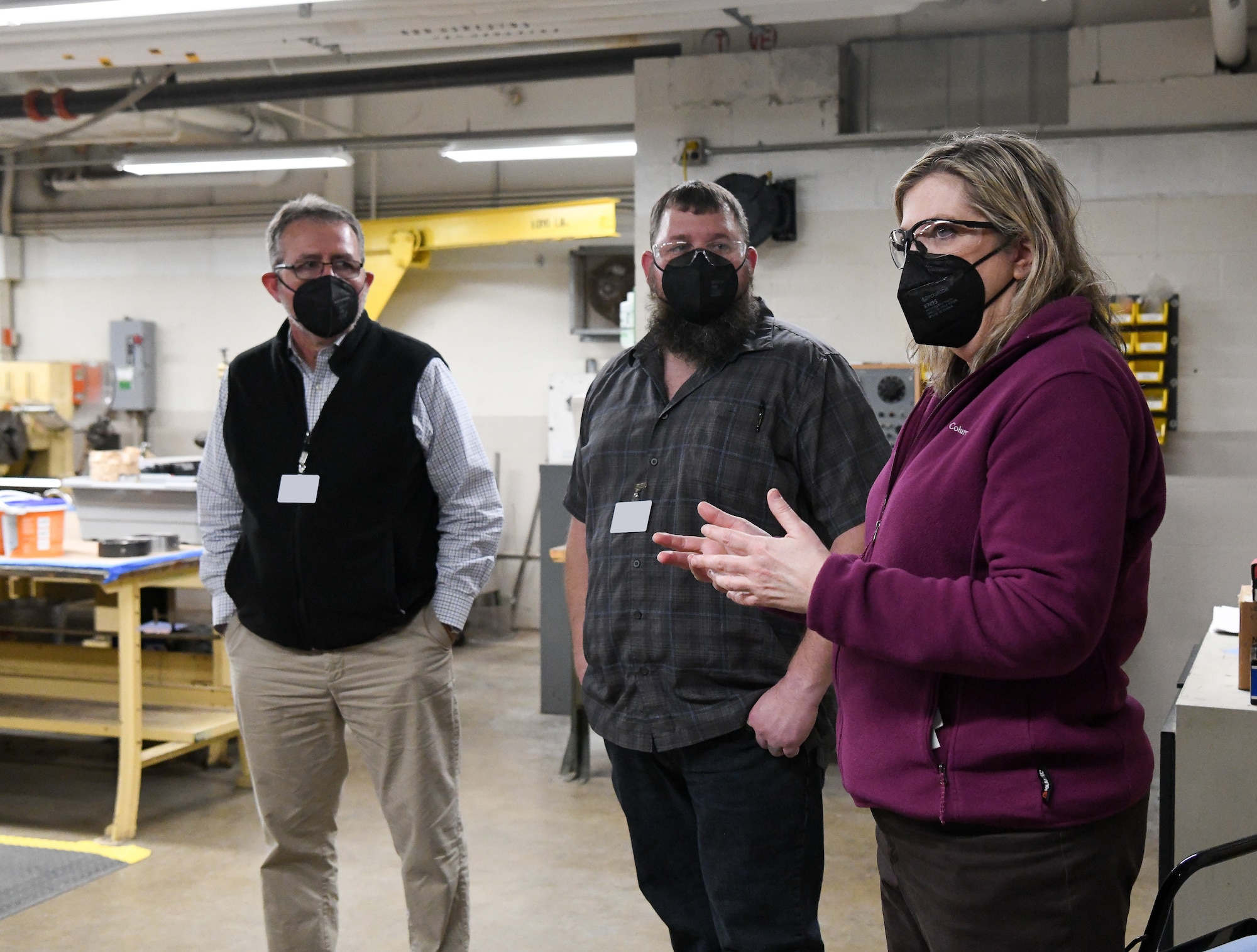 Laurie Winton, right, engineering engagement specialist with the Test Operations and Sustainment contractor for Arnold Engineering Development Complex, answers questions from local teachers and school administrators during a tour of facilities at Arnold Air Force Base, Tenn., Feb. 23, 2022. Also pictured are, from left, Randy Edwards, engineering design technology teacher with Tullahoma High School, and Derek Swiger, machine shop teacher with Tullahoma High School. The educators were being shown the trade job opportunities available at the base to be able to share the information with their students. (U.S. Air Force photo by Jill Pickett) (This image has been altered by obscuring a badge for security purposes.)