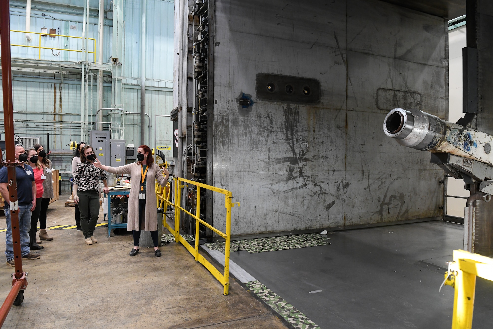 Shannon Tibbals, right, deputy branch manager for Flight Branch with the Test Operations and Sustainment contractor for Arnold Engineering Development Complex, speaks about one of the test carts used in the 16-foot supersonic wind tunnel during a tour of facilities at Arnold Air Force Base, Tenn., March 2, 2022, for local teachers and administrators. The educators were being shown the trade job opportunities available at the base to be able to share the information with their students. (U.S. Air Force photo by Jill Pickett) (This image has been altered by obscuring a badge for security purposes.)