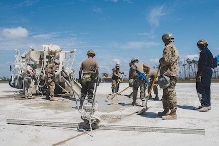 U.S. Air Force Airmen assemble the FRP (Fiber-Reinforced Polymer) to cover a crater on the runway at the Silver Flag exercise site on Tyndall Air Force Base, Florida, March 31, 2022. The primary focus of Silver Flag is to teach Airmen from the civil engineer, force support, and vehicle maintenance squadrons essential skills to complete operations outside of their primary duties. (U.S. Air National Guard photo by Senior Airman Jana Somero)