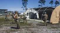 U.S. Air Force Airmen erect an Alaskan Small Shelter System at the Silver Flag exercise site on Tyndall Air Force Base, Florida, March 31, 2022. The primary focus of Silver Flag is to teach Airmen from the civil engineer, force support, and vehicle maintenance squadrons essential skills to complete operations outside of their primary duties. (U.S. Air National Guard photo by Senior Airman Jana Somero)