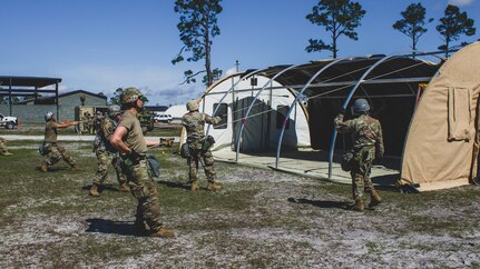 U.S. Air Force Airmen erect an Alaskan Small Shelter System at the Silver Flag exercise site on Tyndall Air Force Base, Florida, March 31, 2022. The primary focus of Silver Flag is to teach Airmen from the civil engineer, force support, and vehicle maintenance squadrons essential skills to complete operations outside of their primary duties. (U.S. Air National Guard photo by Senior Airman Jana Somero)