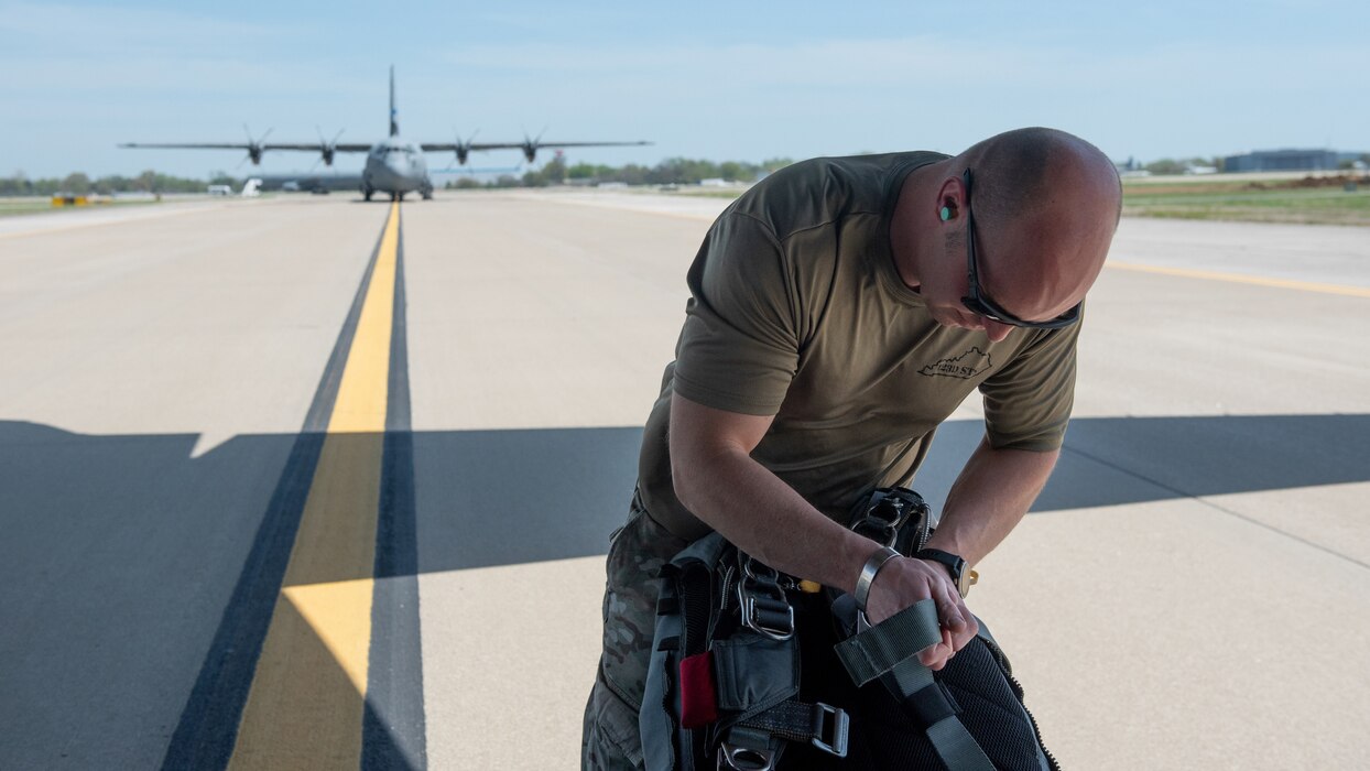 Capt. Bryan Hunt, a special tactics officer with the Kentucky Air National Guard’s 123rd Special Tactics Squadron, checks his parachute at Muhammad Ali International Airport in Louisville, Ky., on April 23, 2022, in preparation for a parachute insertion in the Ohio River for the Thunder Over Louisville air show. Squadron members kicked off the show by jumping with banners for the United States of America and Kentucky. (U.S. Air National Guard photo by Staff Sgt. Clayton Wear)