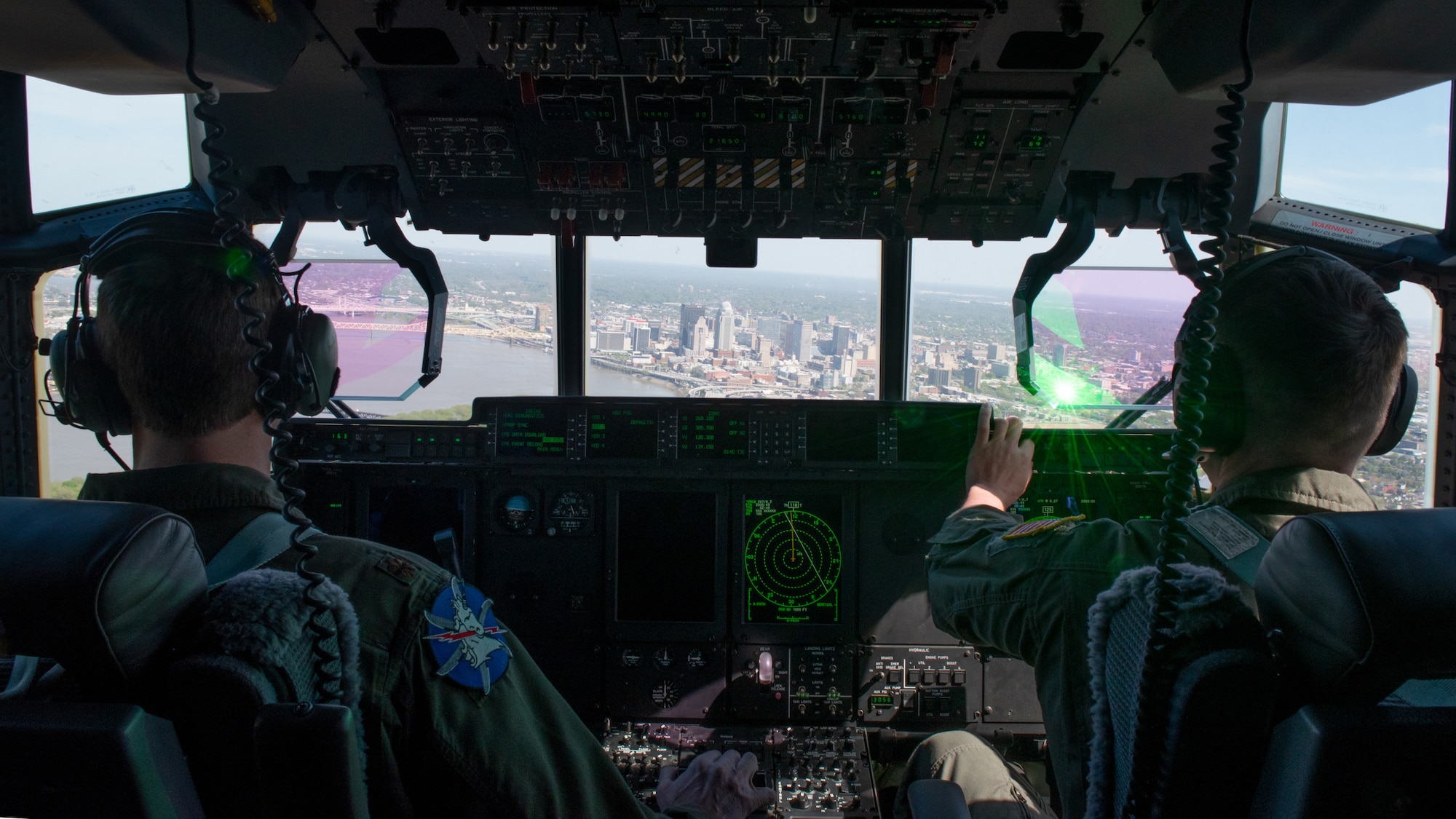 Maj. Chris Boelscher (left) and 1st Lt. Daniel Wormley (right), both C-130J Super Hercules pilots with the Kentucky Air National Guard’s 165th Airlift Squadron, perform their second pass during the Thunder Over Louisville air show on April 23, 2022, in Louisville, Ky. Boelscher flew the C-130J as Airmen from the Kentucky Air Guard’s 123rd Special Tactics Squadron parachuted into the Ohio River with banners for the United States of America and Kentucky. (U.S. Air National Guard photo by Staff Sgt. Clayton Wear)