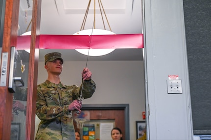 Airman 1st Class Zierse Connor, United States Air Force Honor Guard ceremonial guardsman, cuts the ribbon to the newly renovated United Service Organization resiliency room April, 12, 2022 at Joint Base Anacostia-Bolling, DC. With Support from the 11th Wing, the resiliency room will now feature theater style seating, large screen TVs, pool table, fridge, microwave and other amenities to enjoy. (U.S. Air Force photo by Senior Airman Nilsa Garcia)