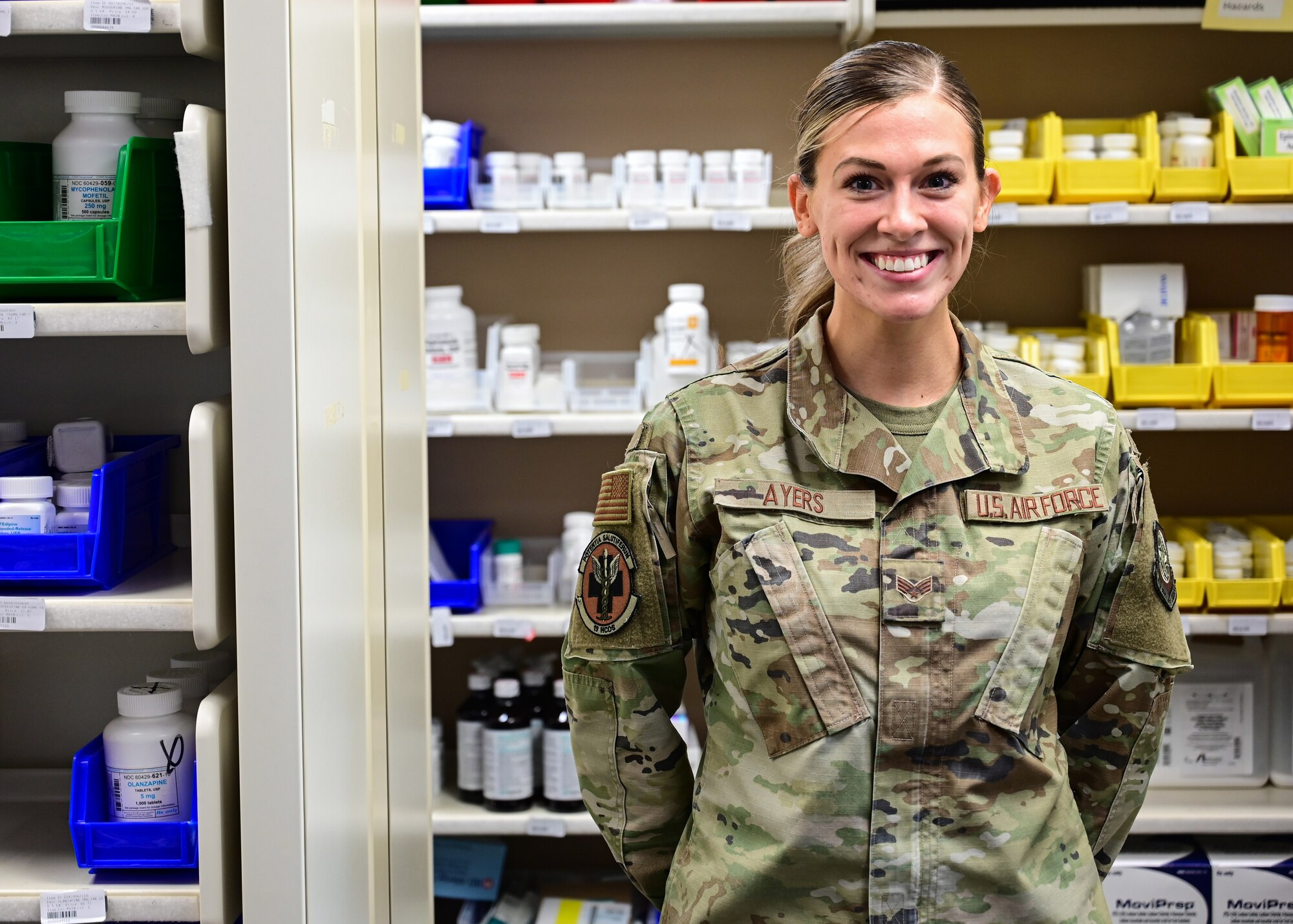An Airman stands in a pharmacy vault.