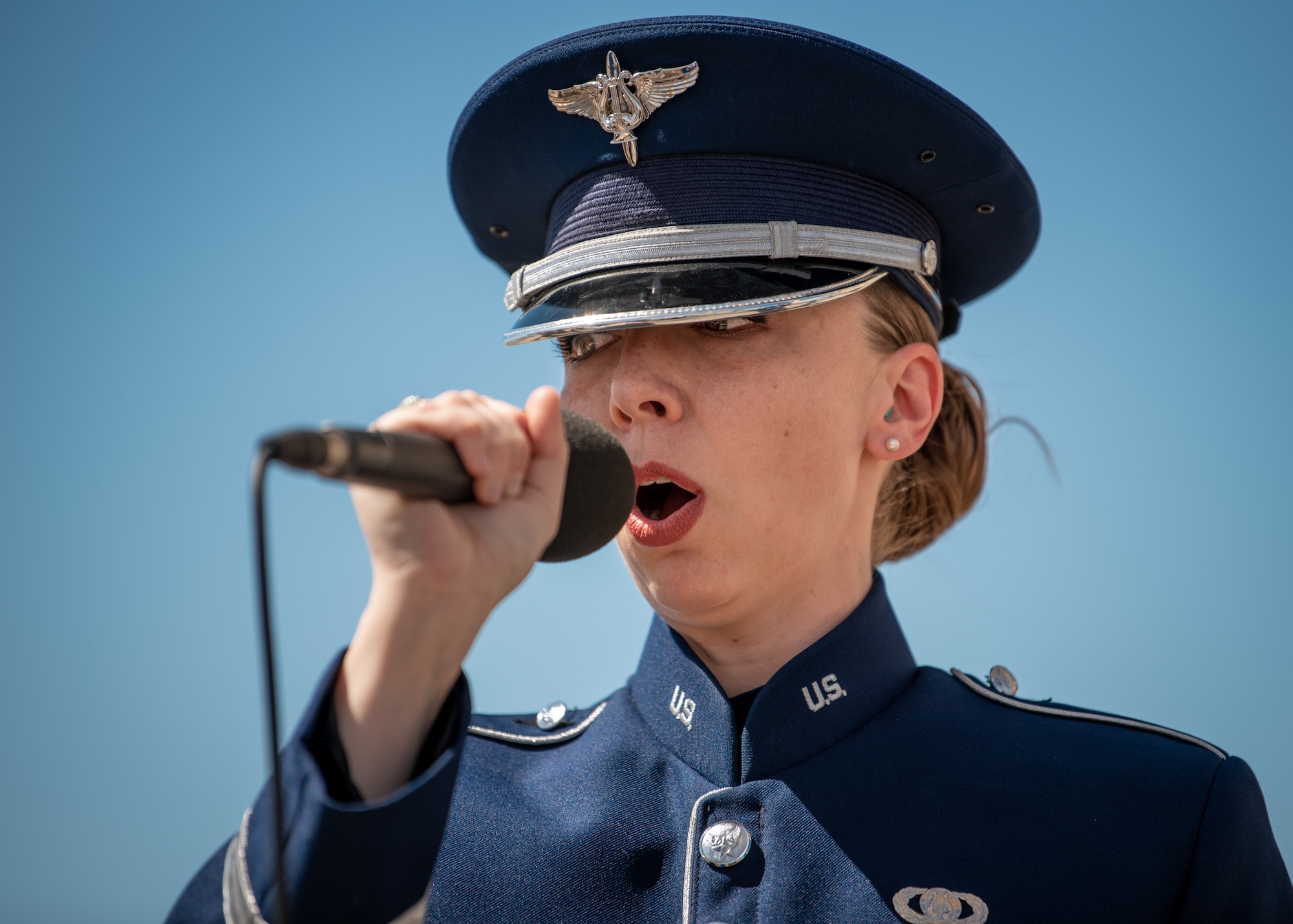 Staff Sgt. Melissa Griffith, a bandsman with the U.S. Air Force Band of Mid-America, performs the Star Spangled Banner during the opening ceremony of the Thunder Over Louisville air show in downtown Louisville, Ky., April 23, 2022. This year’s event celebrated the 75th anniversary of the United States Air Force. (U.S. Air National Guard photo by Dale Greer)