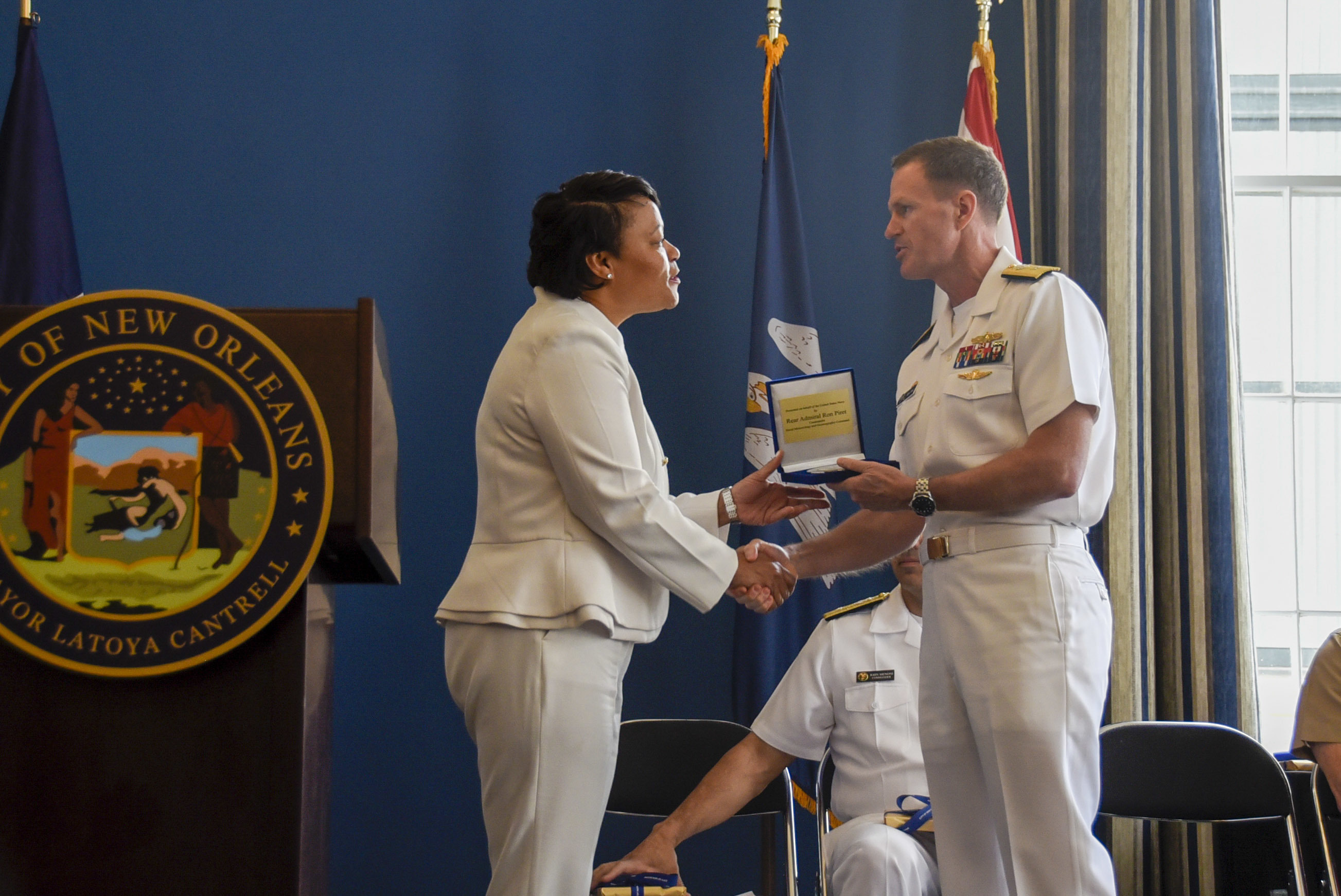 220419-N-LX838-1084 NEW ORLEANS (April 19, 2022) Rear Adm. Ronald J. Piret, Commander, Naval Meteorology and Oceanography Command, gives Mayor LaToya Cantrell a gift at Gallier Hall during a welcoming ceremony as part of Navy Week New Orleans festivities. Navy Weeks are desinged to show Americans the investment they have made in their Navy and increase awareness in cities that do not have a significant Navy presence. (U.S. Navy Photo by Mass Communication Specialist 2nd Class Steven Edgar)