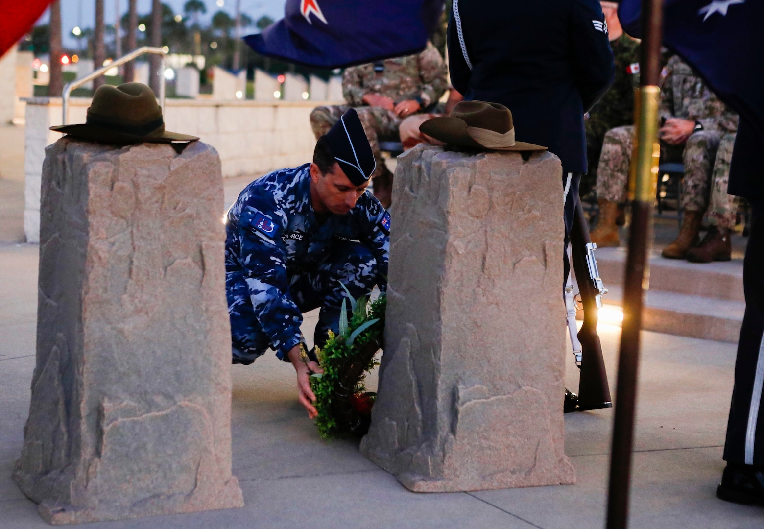 TAMPA, Fla. – Royal Australian Air Force, Air Commodore Harvey Reynolds, a senior national representative (SNR) at U.S. Central Command, lays a wreath at the base of a memorial during an ANZAC Day dawn service at MacDill Air Force Base, April 25, 2022. Though repelled by Ottoman forces, Australian and New Zealand Army Corps (ANZAC) Day commemorates the World War I campaign when Australian and New Zealand forces stood together in effort to capture the Gallipoli Peninsula. ANZAC Day is a day of remembrance in Australia and New Zealand to honor those who served and died in military operations. (U.S. Central Command Public Affairs photo by Tom Gagnier)