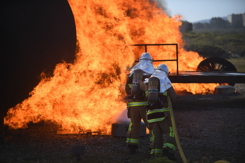A team of firefighters put out a fire around a training aircraft during the joint firefighter integrated readiness ensemble training exercise on Vandenberg Space Force Base, Calif., April 7, 2022. The Vandenberg Fire Department trains on JFIRE annually to retain their certification. (U.S. Space Force photo by Airman 1st Class Ryan Quijas)