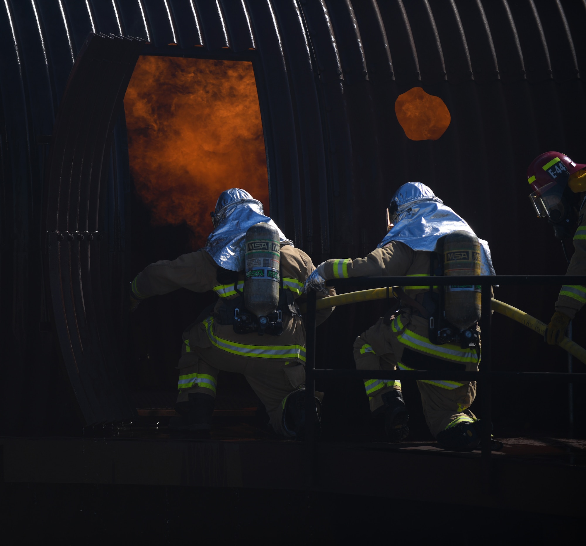 A team of firefighters enter a training aircraft during the joint firefighter integrated readiness ensemble training exercise on Vandenberg Space Force Base, Calif., April 7, 2022. The Vandenberg Fire Department trains on JFIRE annually to retain their certification. (U.S. Space Force photo by Airman 1st Class Ryan Quijas)