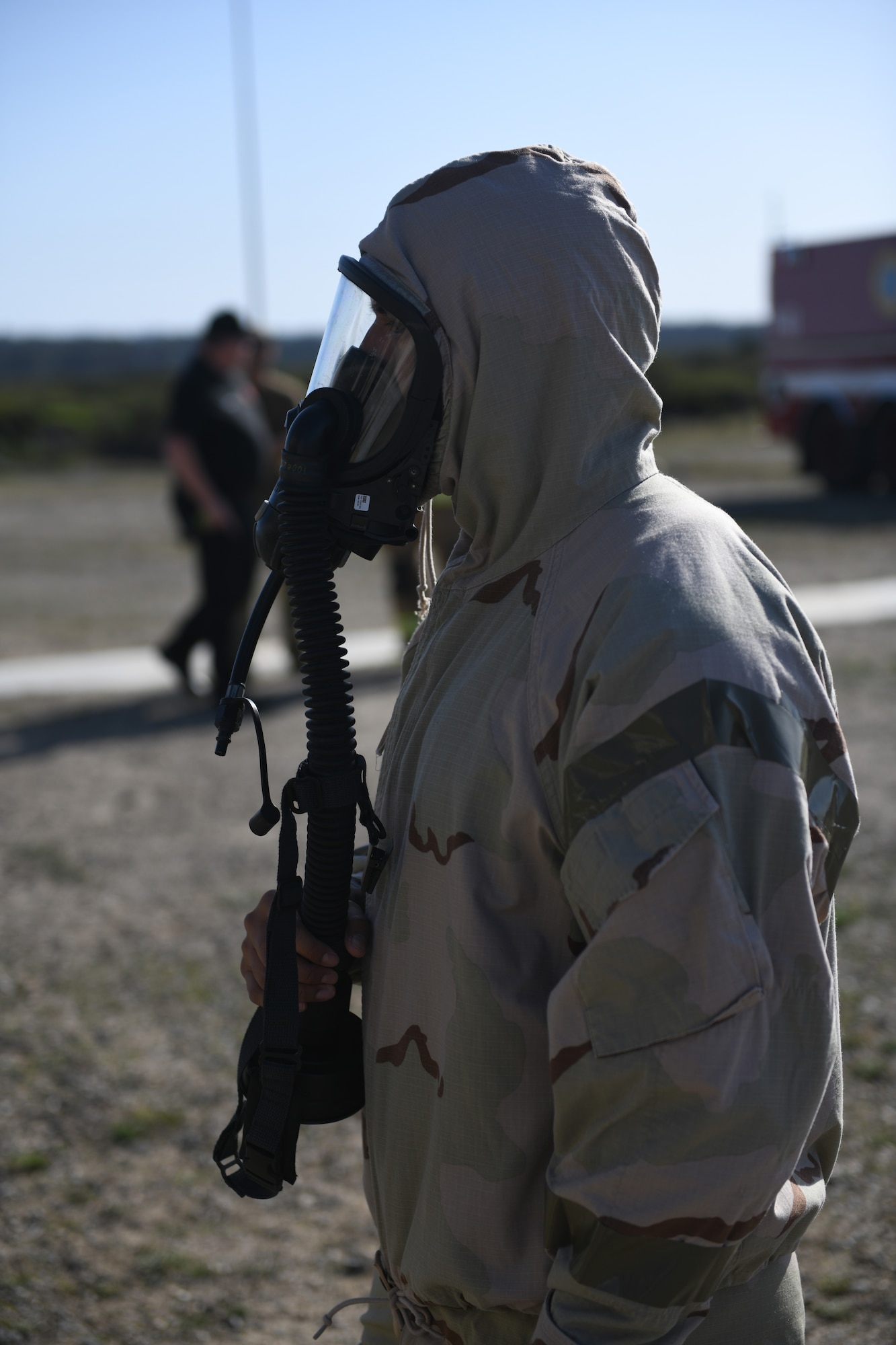 Staff Sgt. Jonathan Martinez, 30th CES firefighter, dons mission oriented protective posture (MOPP) level four gear prior to putting on fire gear for the joint fire integrated readiness ensemble training exercise  on Vandenberg Space Force Base, Calif., April 7, 2022. Firefighters donning the JFIRE carry about 75 pounds of gear when responding to emergencies. (U.S. Space Force photo by Airman 1st Class Ryan Quijas)