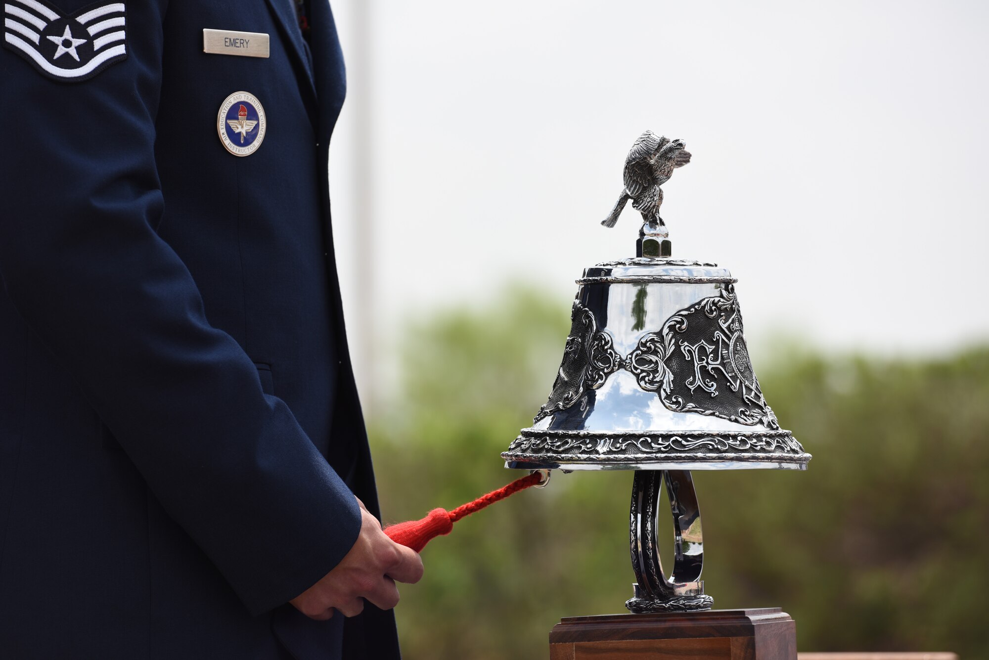 U.S. Air Force Staff Sgt. George Emery Jr., 312th Training Squadron instructor, rings the ceremonial bell during the final call at the annual Department of Defense Fallen Firefighter Memorial Service, Goodfellow Air Force Base, Texas, April 22, 2022. The ceremonial bell was rung five times as a send off to the firefighters that laid down their lives on the line of duty. (U.S. Air Force by Senior Airman Michael Bowman)