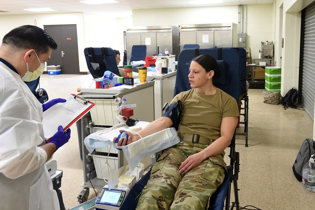 Maj. Jodi Wernikoff, company commander for the Headquarters and Headquarters Company, 85th USARSC donates blood during an Armed Services Blood Program event.