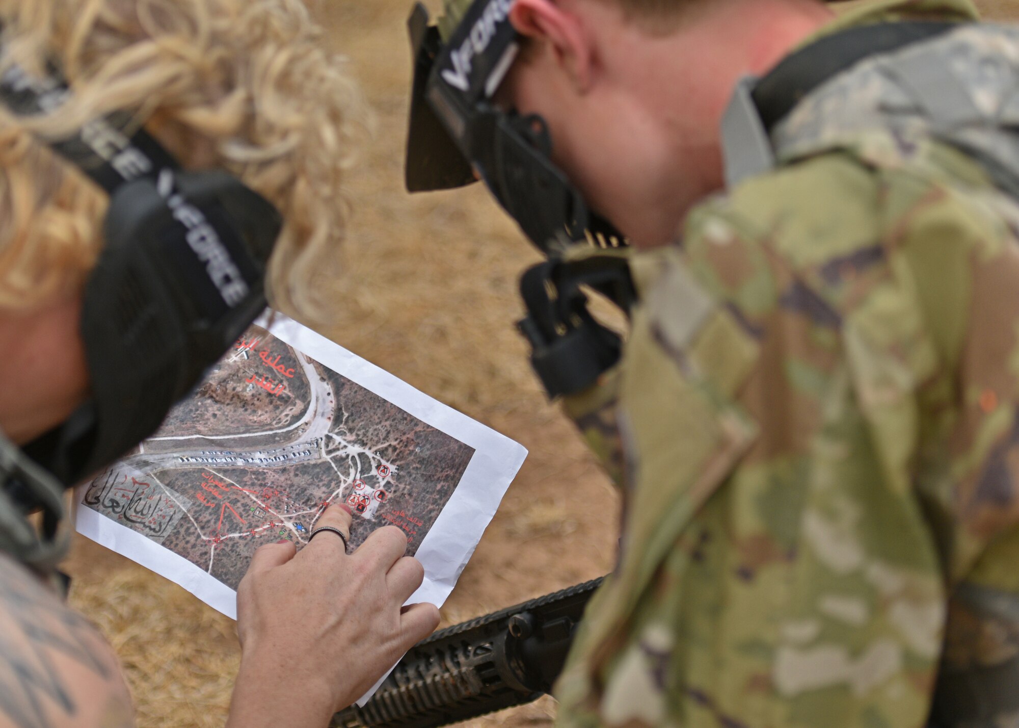 An Angelo State University Air Force Reserve Officers’ Training Corps cadet works with a 17th Training Wing member during a field training exercise at Goodfellow Air Force Base, Texas, April 22, 2022. Cadets completed simulated missions including attacks and reconnaissance throughout the exercise. (U.S. Air Force photo by Senior Airman Ashley Thrash)