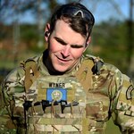 Staff Sgt. Joseph Wyner, state marksmanship coordinator, Joint Force Headquarters, New Hampshire Army National Guard, surveys and scores targets after firing in a match at the 51st Winston P. Wilson Pistol and Rifle Championships at Camp Robinson, Ark., March 31, 2022.