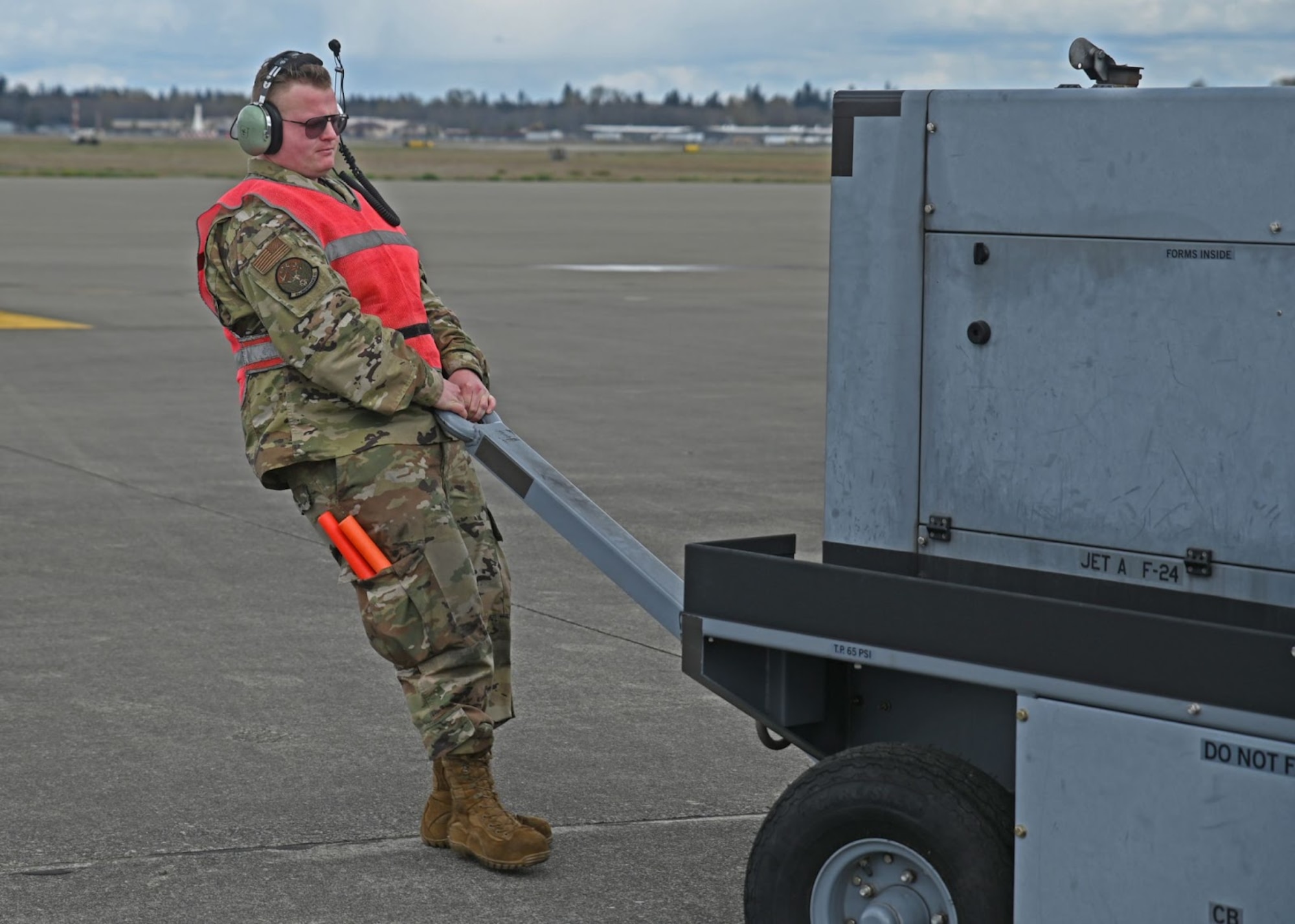 U.S. Air Force Staff Sgt. Oden Bagley, aircraft hydraulics specialist with the 62nd Maintenance Squadron, moves a power cart on the flightline during Agile Combat Employment Training at Joint Base Lewis-McChord, Washington, April 21, 2022. The week-long ACE training encourages Airmen to learn and perform outside their designated specialty to streamline maintenance operations. (U.S. Air Force photo by Airman 1st Class Callie Norton)