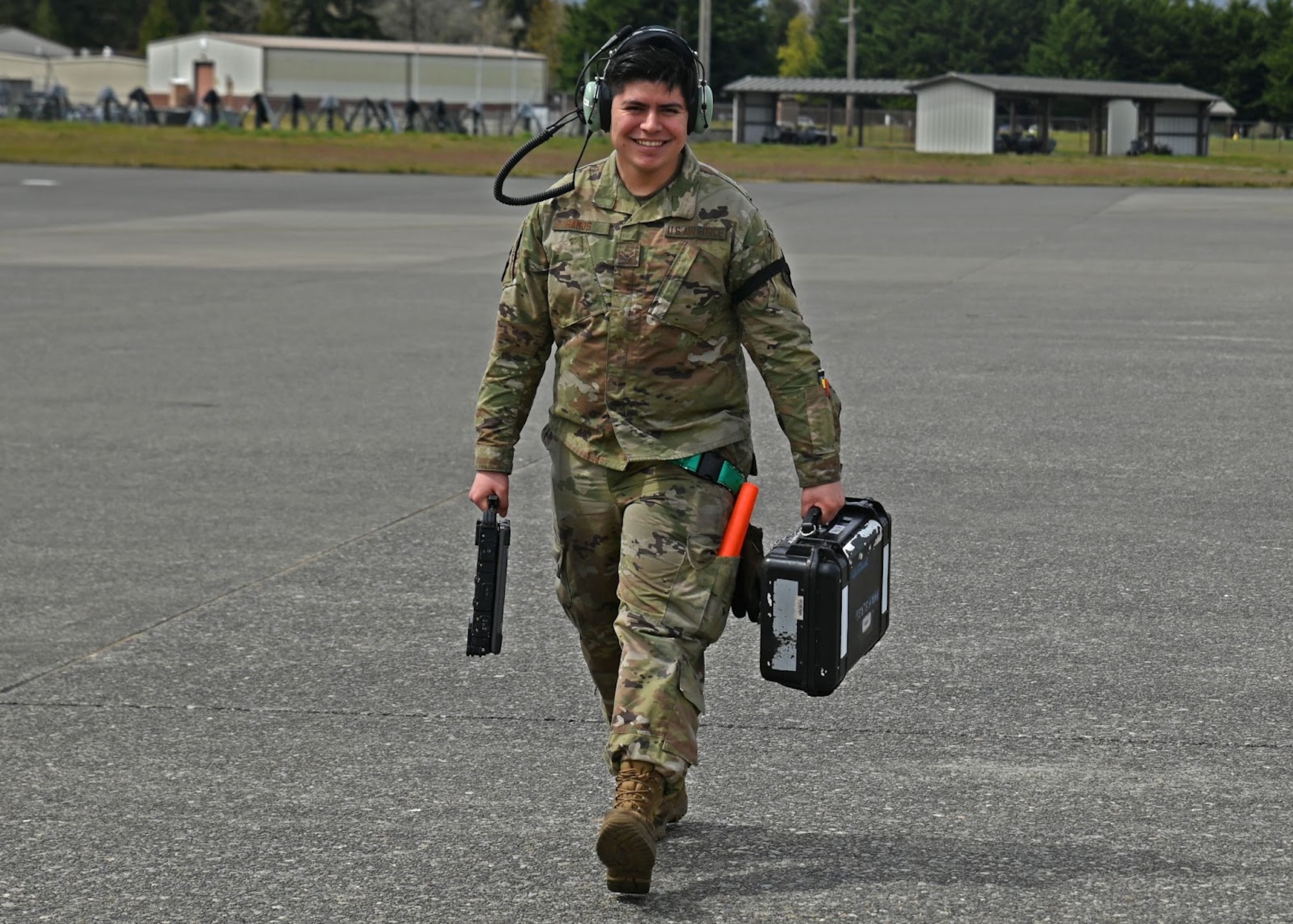 U.S. Air Force Airman 1st Class Carlos Ramos, crew chief with the 62nd Aircraft Maintenance Squadron, carries a launch kit and computer used during Agile Combat Employment training at Joint Base Lewis-McChord, Washington, April 21, 2022. The week-long ACE training reinforces the team dynamic required for maintenance Airmen to operate effectively in limited support locations while continuing to maintain mission effectiveness. (U.S. Air Force photo by Airman 1st Class Callie Norton)