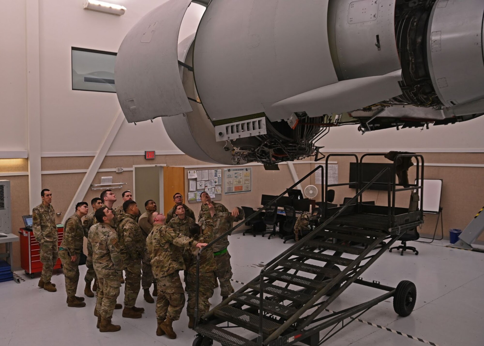 Airmen with the 62nd Maintenance Group observe a training C-17 Globemaster III engine during Agile Combat Employment training at Joint Base Lewis-McChord, Washington, April 21, 2022. The week-long ACE training reinforces the team dynamic required for maintenance Airmen to operate effectively in limited support locations while continuing to maintain mission effectiveness. (U.S. Air Force photo by Airman 1st Class Callie Norton)