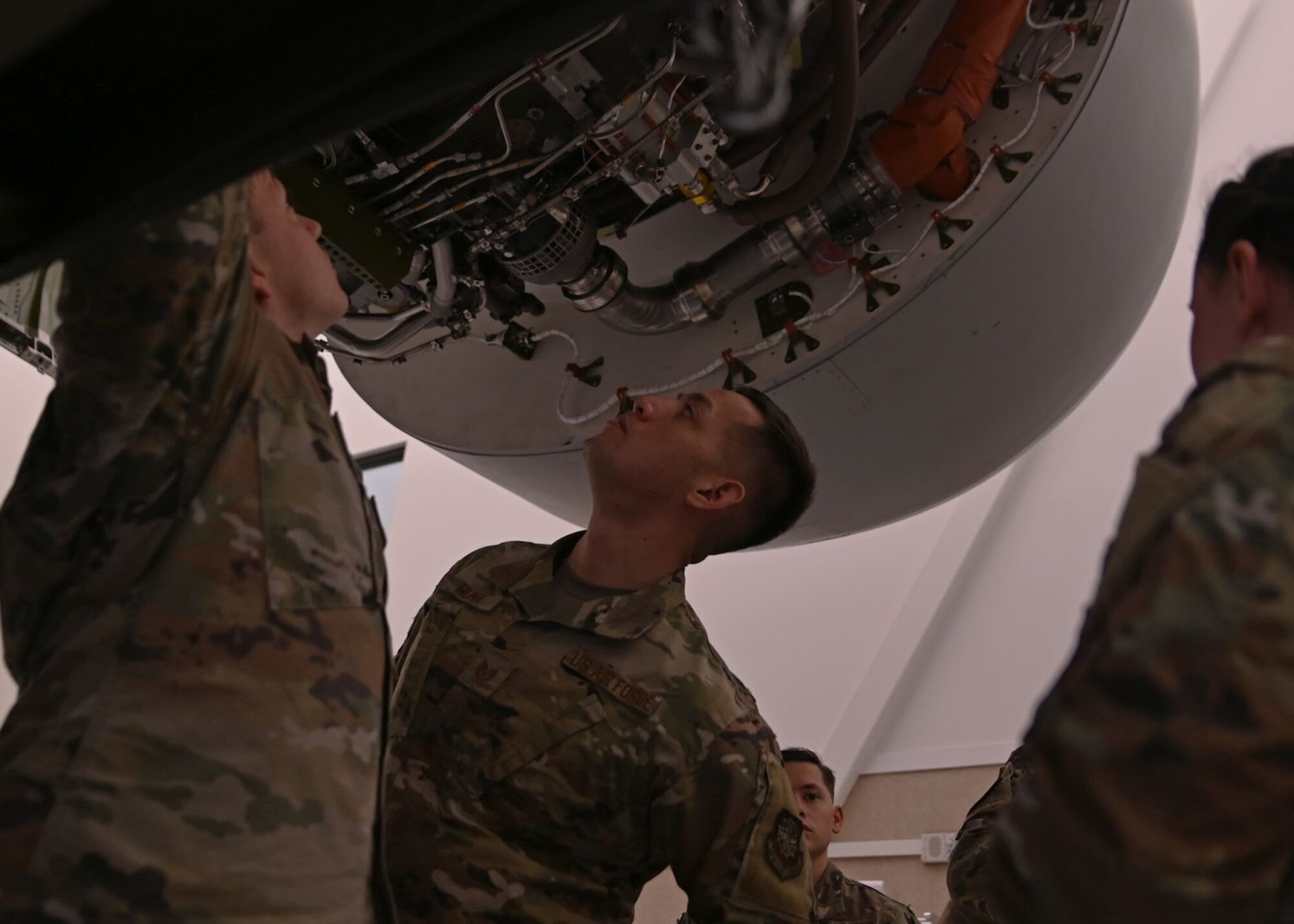 Airmen with the 62nd Maintenance Group observe a training C-17 Globemaster III engine during Agile Combat Employment training at Joint Base Lewis-McChord, Washington, April 21, 2022. The week-long ACE training reinforces the team dynamic required for maintenance Airmen to operate effectively in limited support locations while continuing to maintain mission effectiveness. (U.S. Air Force photo by Airman 1st Class Callie Norton)