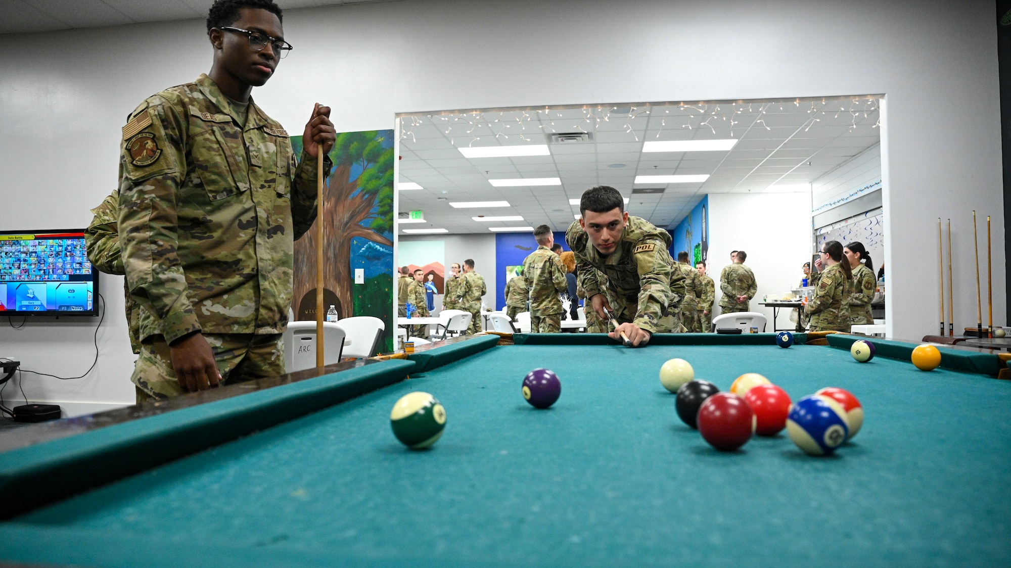 Right, Airman 1st Class Raymond Corona and Airman Cameron Deas, 75th Logistics Readiness Squadron, play pool during a grand opening of the Airman Recreation Center at Hill Air Force Base, Utah