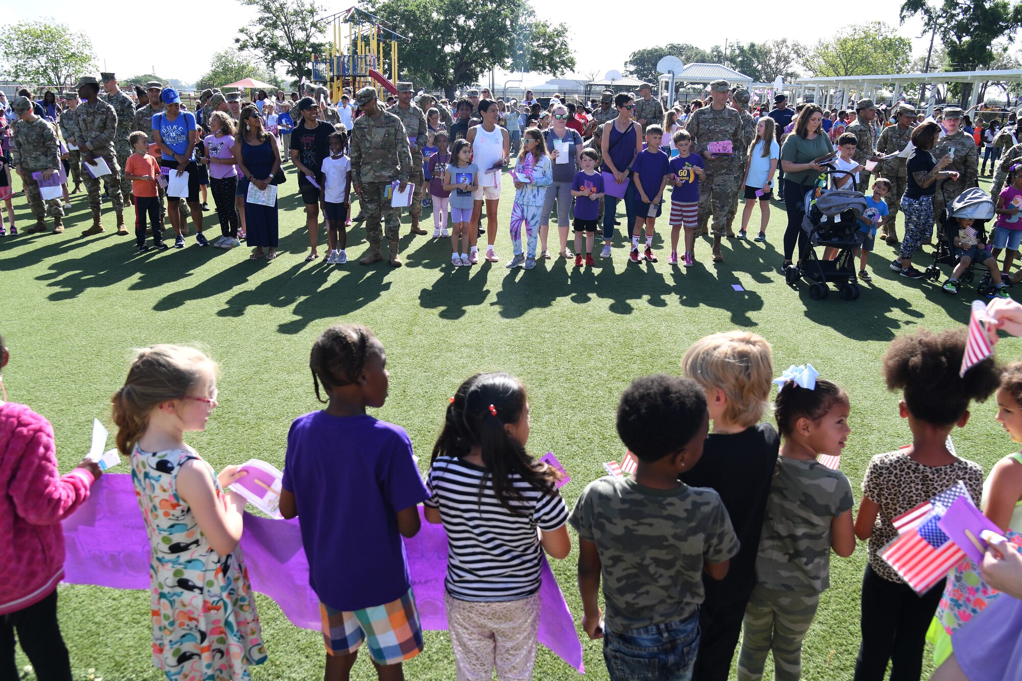 Keesler personnel attend the Back Bay Elementary School Military Honor Walk in Biloxi, Mississippi, April 25, 2022. The walk, held in recognition of the Month of the Military Child, allows students the opportunity to honor all military personnel affiliated with the school and the surrounding community. (U.S. Air Force photo by Kemberly Groue)