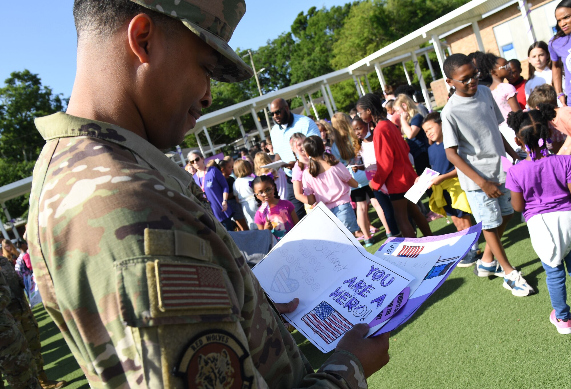 U.S. Air Force Chief Master Sgt. Nicholas Scott, 336th Training Squadron senior enlisted leader, views hand-made appreciation cards during the Back Bay Elementary School Military Honor Walk in Biloxi, Mississippi, April 25, 2022. The walk, held in recognition of the Month of the Military Child, allows students the opportunity to honor all military personnel affiliated with the school and the surrounding community. (U.S. Air Force photo by Kemberly Groue)