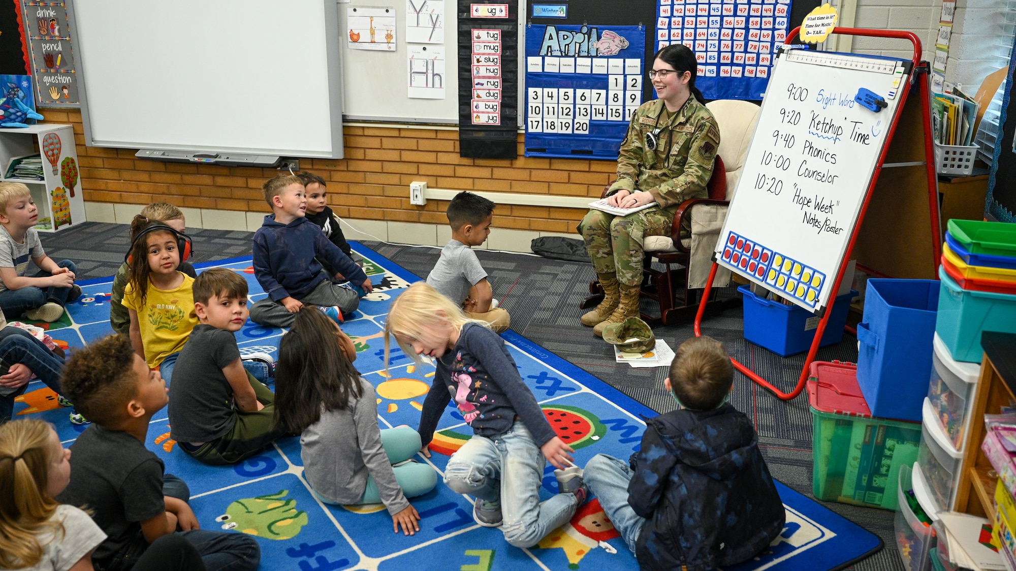 Airmen Payton Rodriguez, 421st Fighter Generation Squadron, reads to students during a Heroes Reading event at Hill Field Elementary School, April 22, 2022. The Heroes Reading program is an annual event conducted by the Hill AFB School Liaison office in partnership with local elementary schools. The event is held each spring in conjuction with April's Month of the Military Child. This year marks a relaunch of the program after a hiatus due to the COVID-19 pandemic. During the month, Airmen volunteers will visit three schools and read to more than 1,400 students. (U.S. Air Force photo by R. Nial Bradshaw)