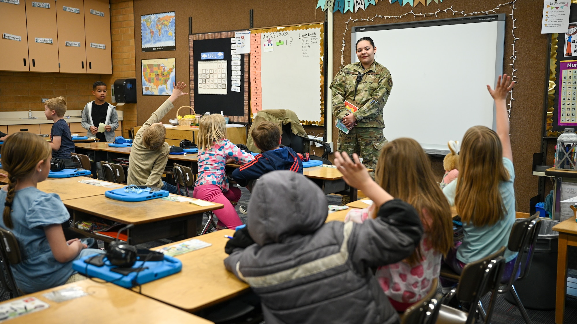 Senior Airman Karen Vega, Ground Based Strategic Deterrent Directorate, listens to a student's question at Hill Field Elemenatary School during a Heroes Reading event, April 22, 2022. The Heroes Reading program is an annual event conducted by the Hill AFB School Liaison office in partnership with local elementary schools. The event is held each spring in conjuction with April's Month of the Military Child. This year marks a relaunch of the program after a hiatus due to the COVID-19 pandemic. During the month, Airmen volunteers will visit three schools and read to more than 1,400 students. (U.S. Air Force photo by R. Nial Bradshaw)