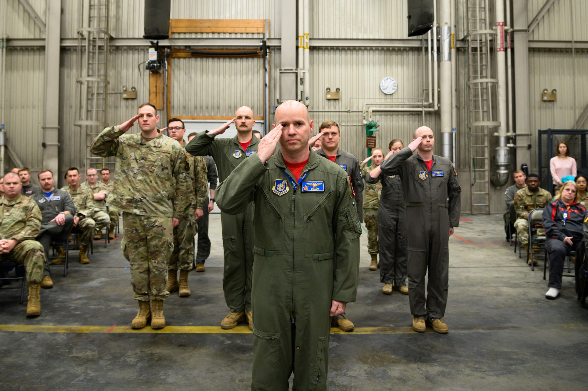 U.S. Airmen assigned to the 18th Aggressor Squadron render a salute during an 18th AGRS change of command ceremony on Eielson Air Force Base, Alaska, April 22, 2022.