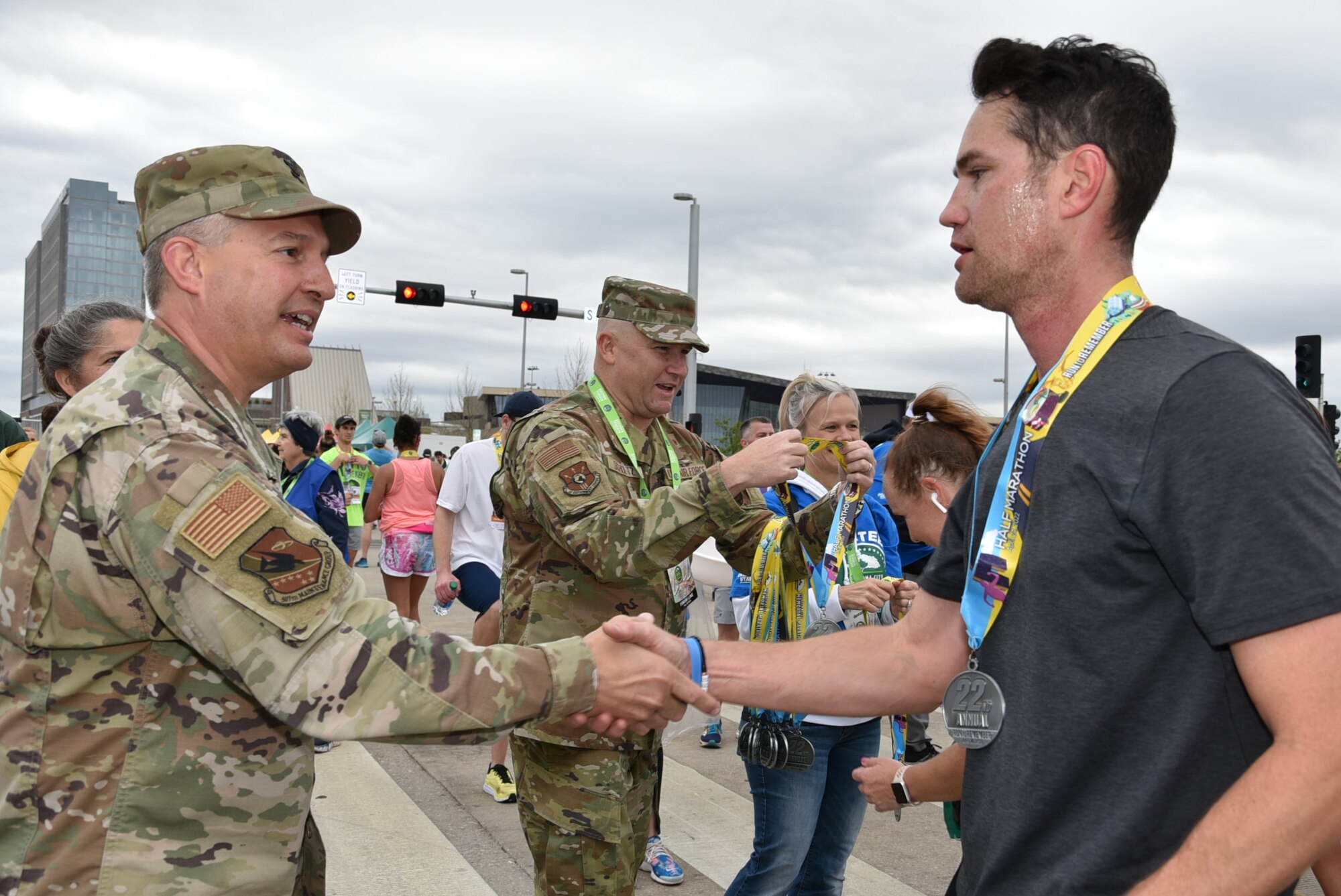 Tinker Air Force Base senior leaders handed out medals to runners at the finish line of the Oklahoma City Memorial Marathon April 24, 2022.