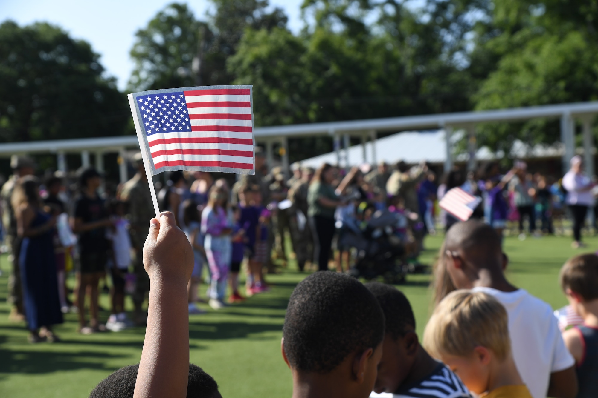 A U.S. Flag is displayed during the Back Bay Elementary School Military Honor Walk in Biloxi, Mississippi, April 25, 2022. The walk, held in recognition of the Month of the Military Child, allows students the opportunity to honor all military personnel affiliated with the school and the surrounding community. (U.S. Air Force photo by Kemberly Groue)