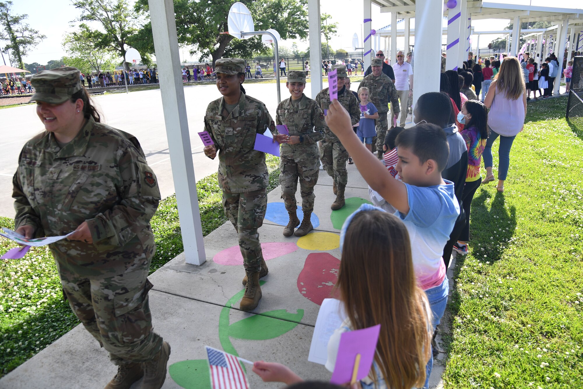 Keesler personnel participate in the Back Bay Elementary School Military Honor Walk in Biloxi, Mississippi, April 25, 2022. The walk, held in recognition of the Month of the Military Child, allows students the opportunity to honor all military personnel affiliated with the school and the surrounding community. (U.S. Air Force photo by Kemberly Groue)