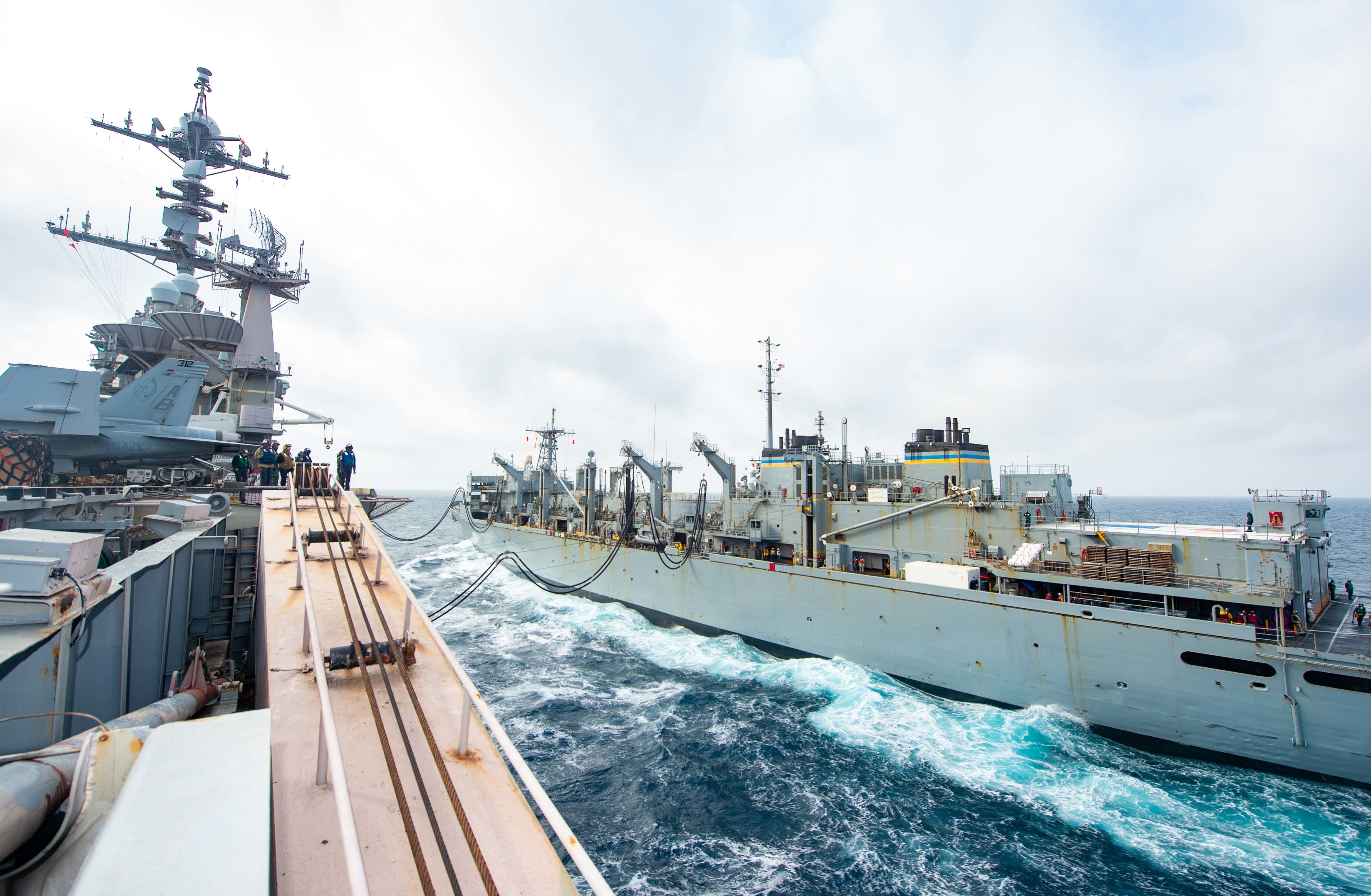 The Nimitz-class aircraft carrier USS Harry S. Truman (CVN 75) transits alongside the fast combat support ship USNS Supply (T-AOE6) during a replenishment-at-sea, April 21, 2022.