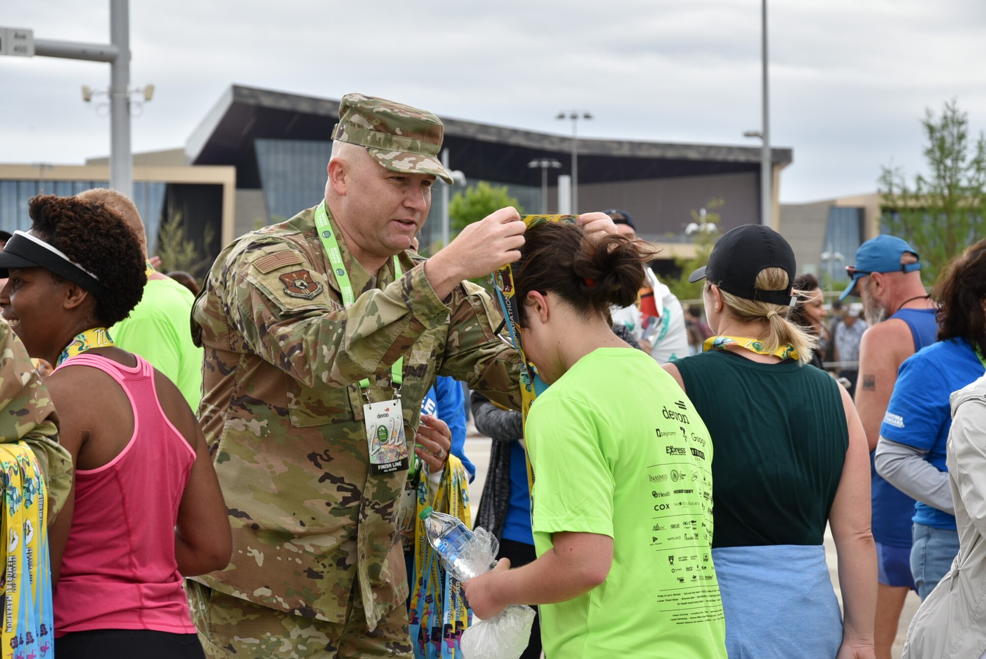 Tinker Air Force Base senior leaders handed out medals to runners at the finish line of the Oklahoma City Memorial Marathon April 24, 2022.