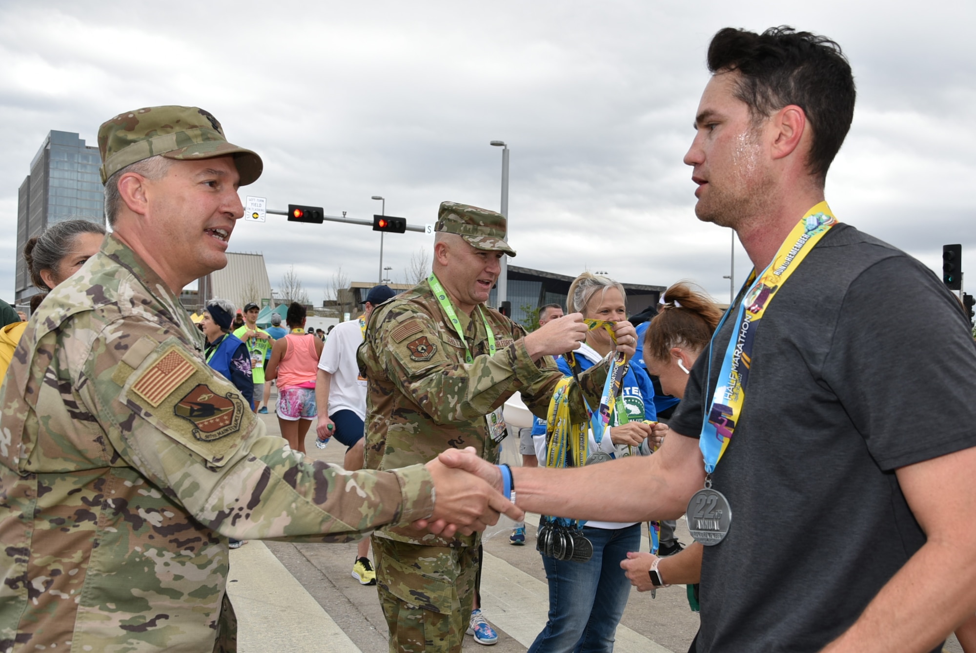 Tinker Air Force Base senior leaders handed out medals to runners at the finish line of the Oklahoma City Memorial Marathon April 24, 2022.