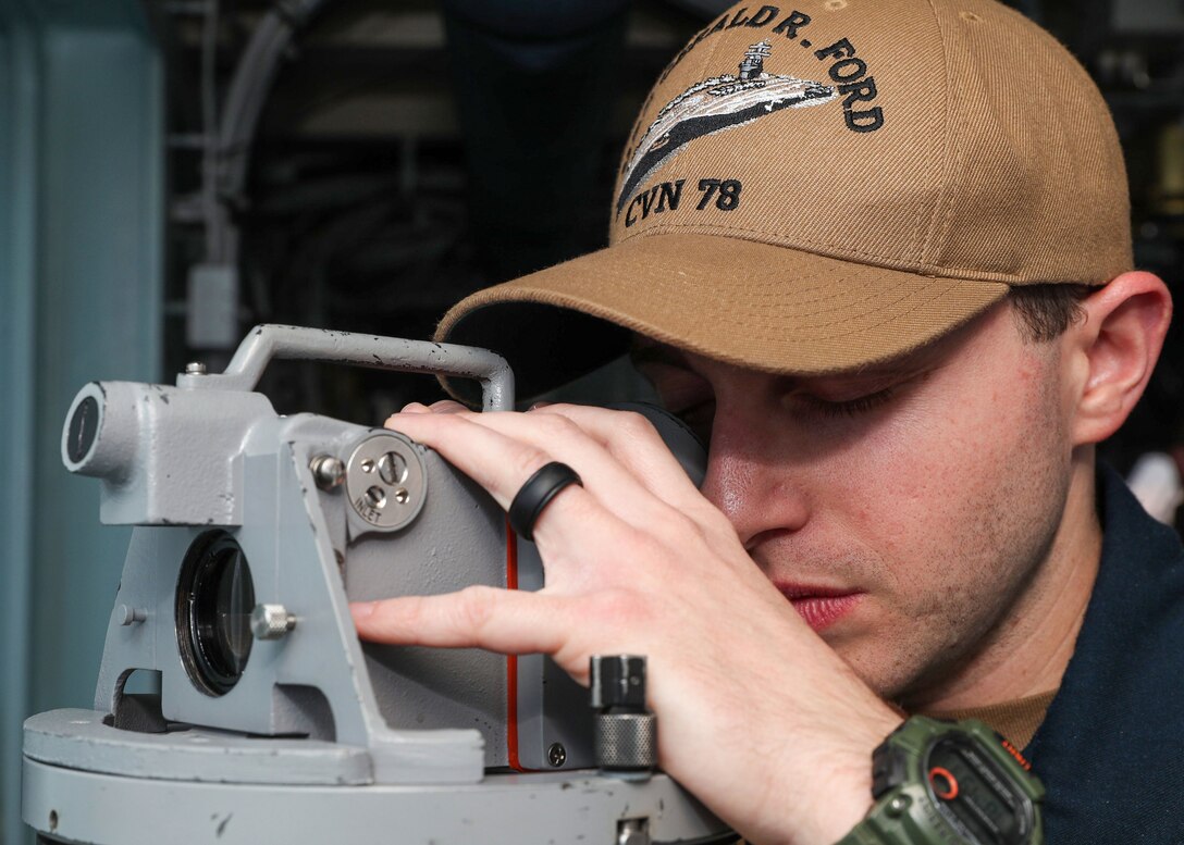 Lt. Ryan Feingold, from Miami, stands watch as the junior officer of the deck on the bridge of the aircraft carrier USS Gerald R. Ford (CVN 78), April 21, 2022.