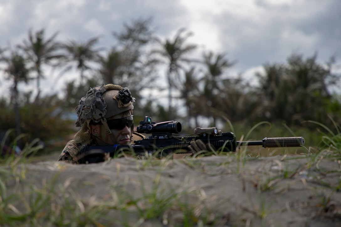 A U.S. Marine with 1st Battalion, 3d Marines, 3d Marine Division, provides security for an amphibious landing during Balikatan 22 at Appari, Philippines, March 28, 2022. Balikatan is an annual exercise between the Armed Forces of the Philippines and U.S. military designed to strengthen bilateral interoperability, capabilities, trust, and cooperation built over decades shared experiences. Balikatan, Tagalong for ‘shoulder-to-shoulder,’ is a longstanding bilateral exercise between the Philippines and the United States highlighting the deep-rooted partnership between both countries. Balikatan 22 is the 37th iteration of the exercise and coincides with the 75th anniversary of the U.S.-Philippine security cooperation. (U.S. Marine Corps photo by Sgt. Melanye Martinez)