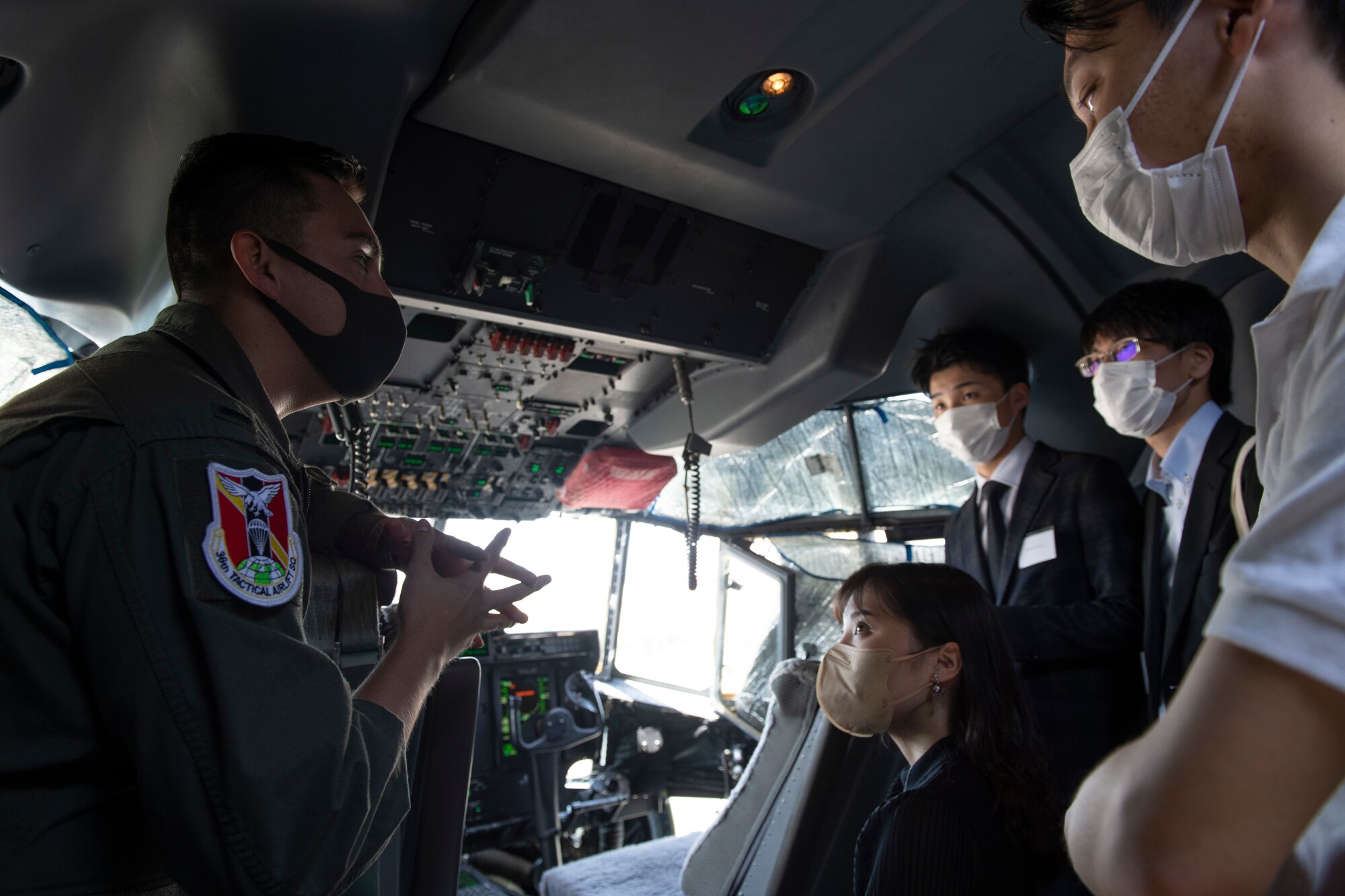 A pilot with the 36th Airlift Squadron, 1st Lt. Kevin Mendez, left, explains the 36th AS mission and C-130J Super Hercules capabilities during an Ambassador’s Youth Council tour at Yokota Air Base, Japan, April 22, 2022. Mendez explained that a C-130J can fly lower and slower over drop zones compared to larger cargo aircraft and how these aircraft play an important role across the Indo-Pacific. (U.S. Air Force photo by Tech. Sgt. Joshua Edwards)