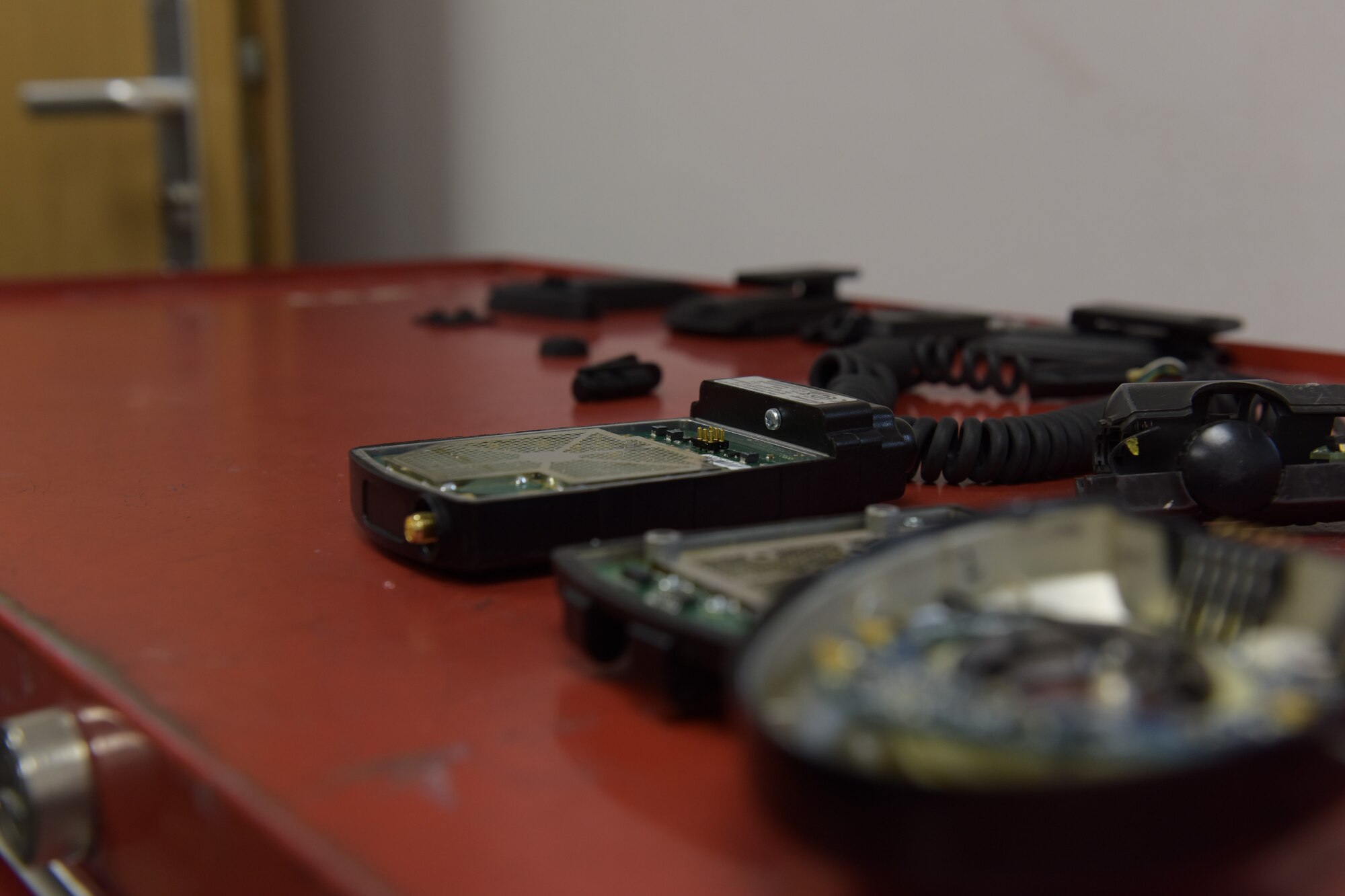 Broken headsets and other equipment sit on a toolbox