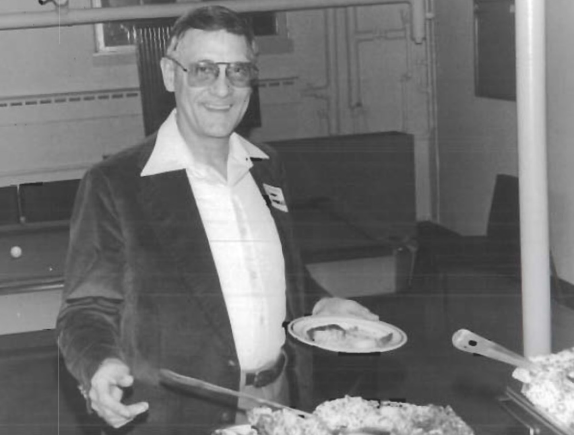 Col. Forest A. Singhoff, OSI Commander, leads the way through an “Alaskan Special Dinner” buffet during a visit to OSI District 81 at Elmendorf Air Force Base in 1978. (U.S. Air Force photo).